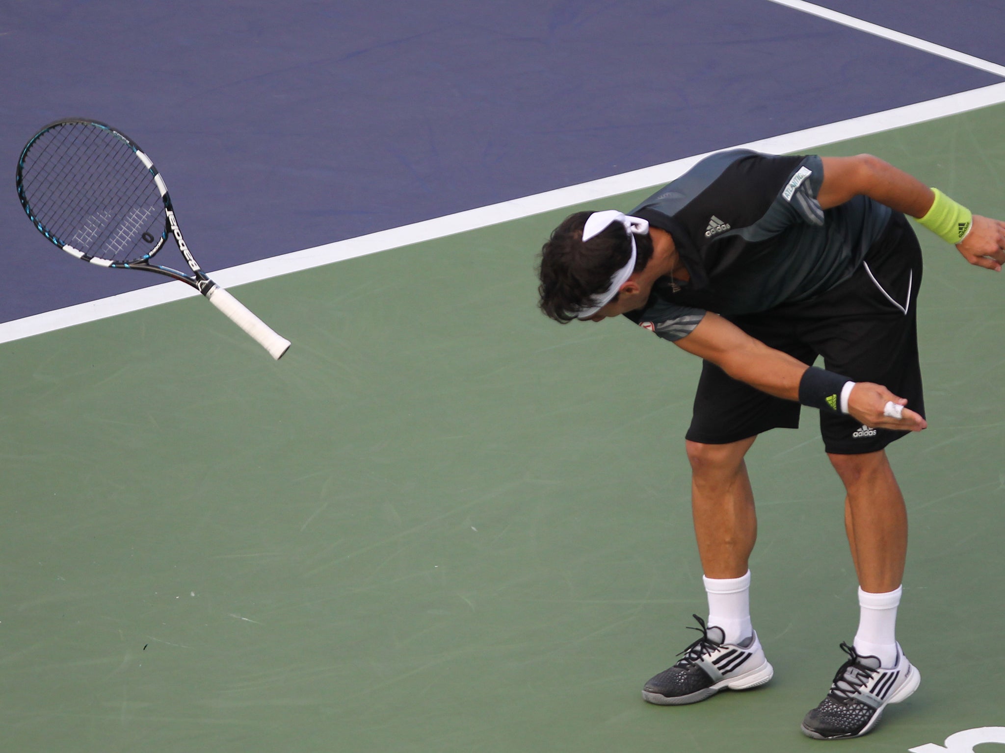 Fabio Fognini of Italy throws his racquet during his match against Chuhan Wang