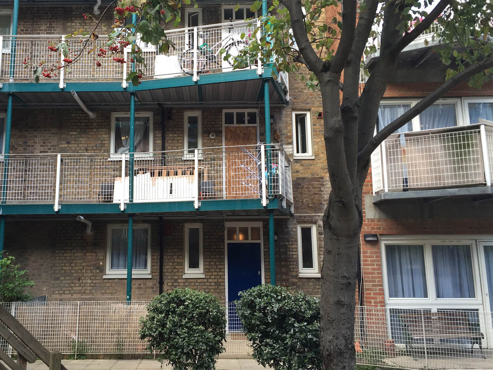 The flat (centre, boarded-up) in west London where Tarik Hassane was arrested along with three other men