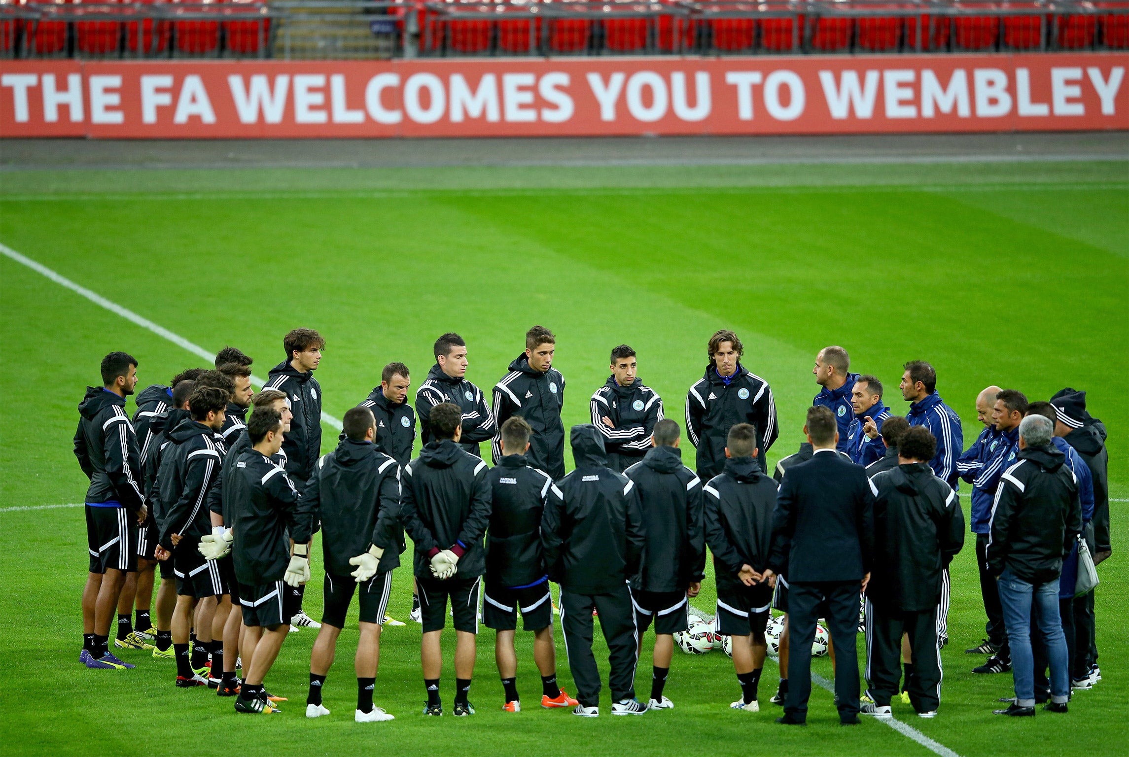 The San Marino squad have a team talk on the pitch during their training session at Wembley Stadium