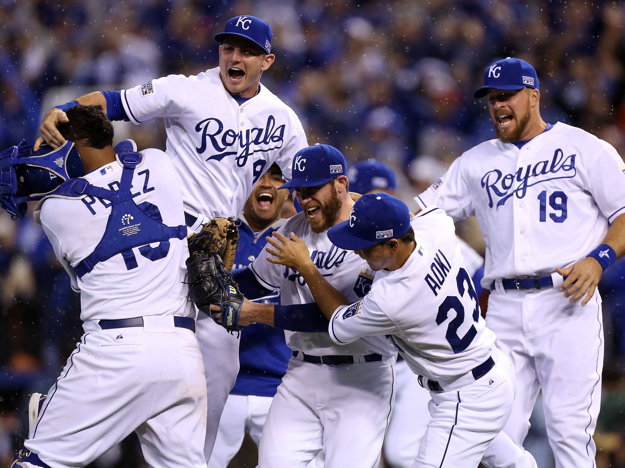 Greg Holland #56 celebrates with Norichika Aoki #23 of the Kansas City Royals after defeating the Los Angeles Angels 8-3