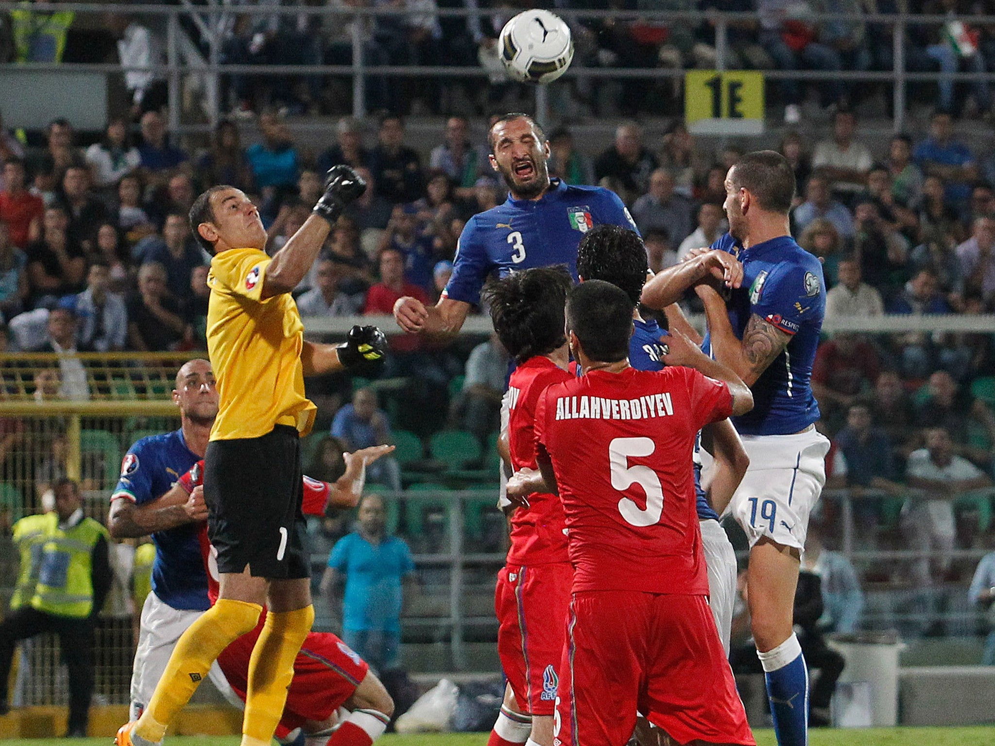 Giorgio Chiellini (centre) rises to score Italy’s opener
last night. The defender scored all three goals in their 2-1 win