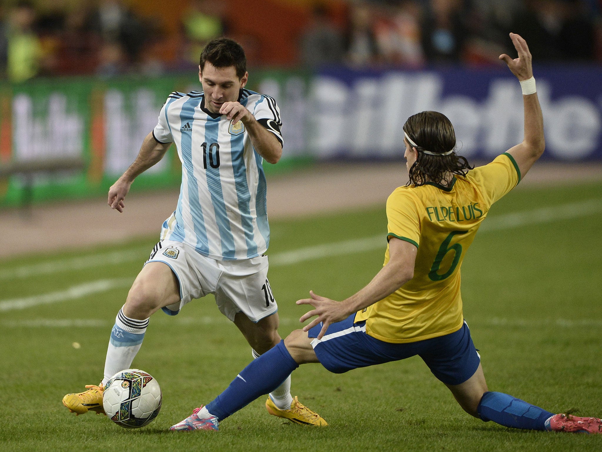 Lionel Messi takes on Filipe Luis