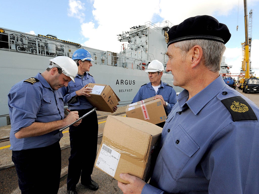 RFA Argus Executive Officer, Chief Officer Shane Wood (left) checks the first load of supplies for the medical ship RFA Argus