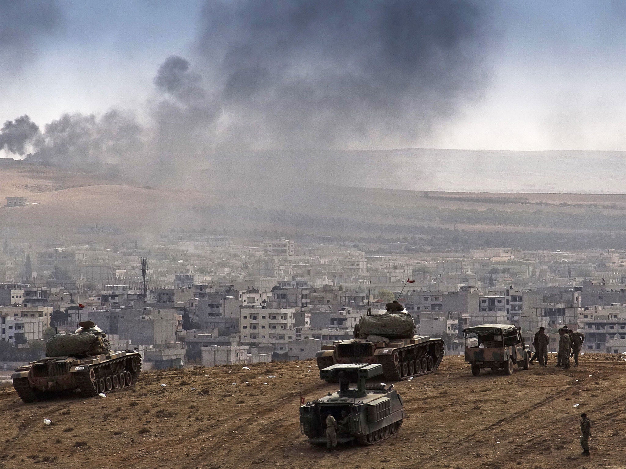 The US has made its first aid drops to Kurdish fighters in Kobani with supplies from the Iraqi authorities