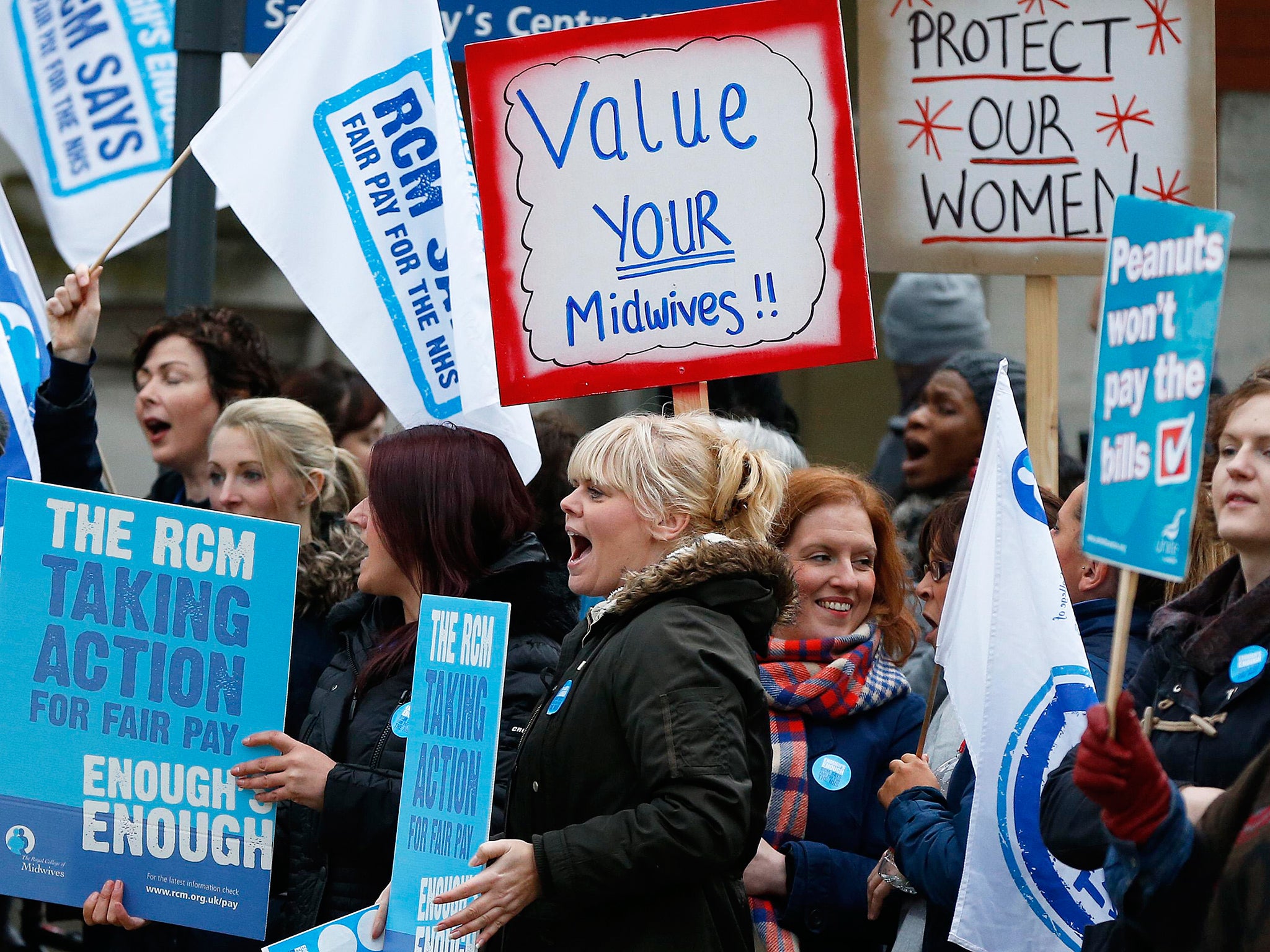 Midwives shout as they stand on a picket line outside St Mary's Hospital in Manchester