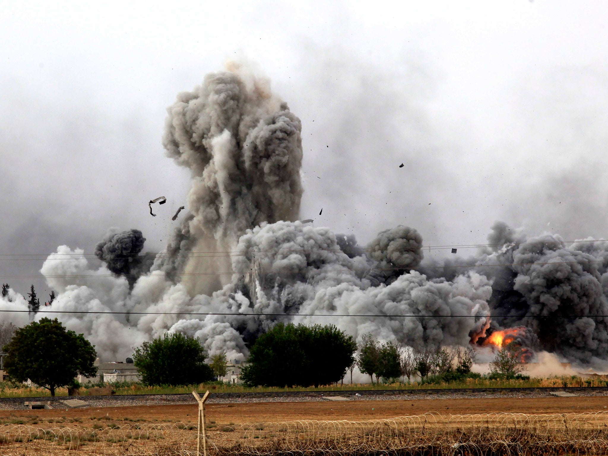 Smoke rises from the Syrian town of Kobani, seen from near the Mursitpinar border crossing on the Turkish-Syrian border in the southeastern town of Suruc.