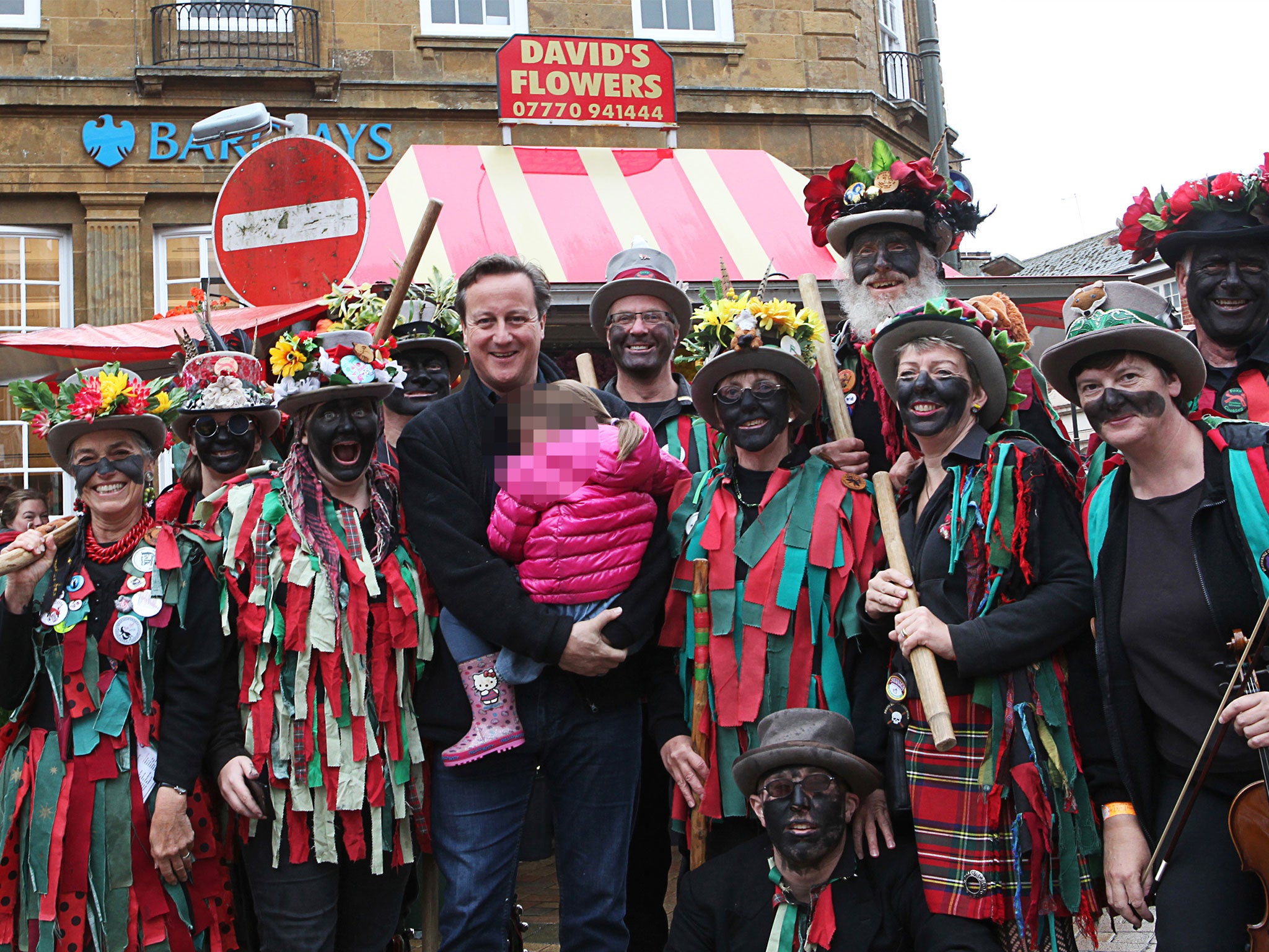 David Cameron poses with blacked-up Morris dancers at the Banbury Folk Festival