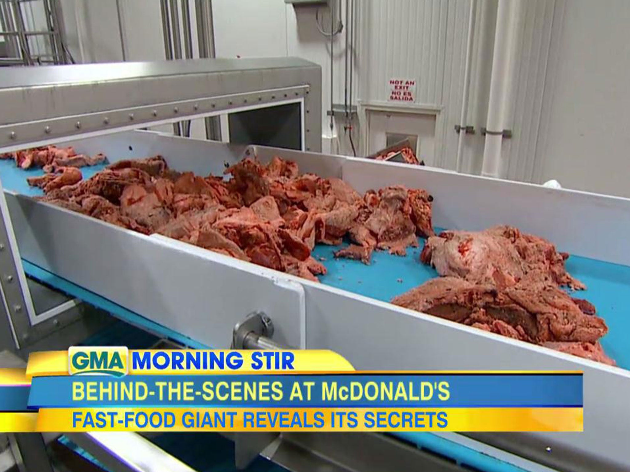 Meat on a conveyor belt inside a McDonald's food plant