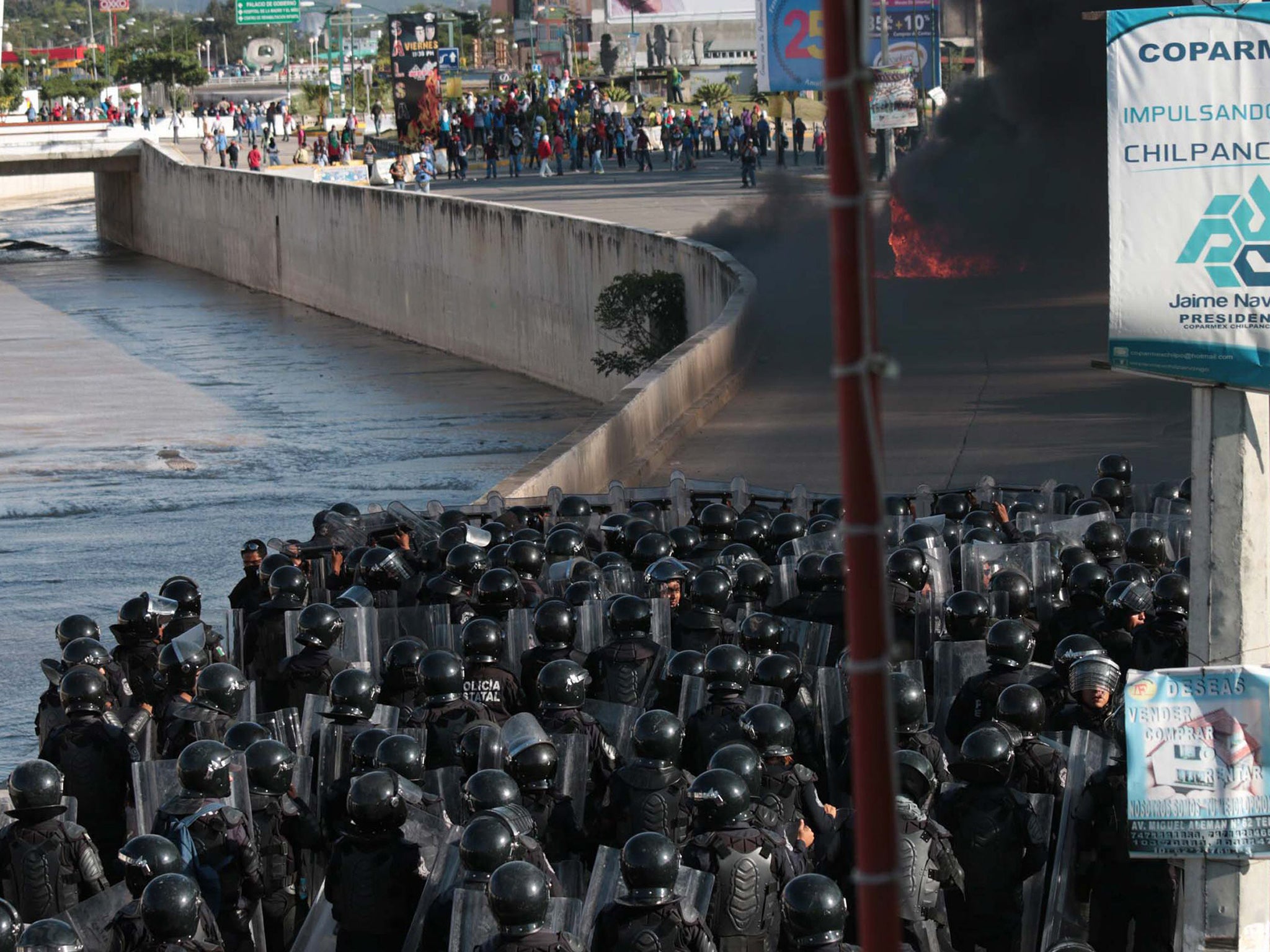 Anti-riot police are on guard as students try to get into Government palace, in Chilpancingo (EPA)