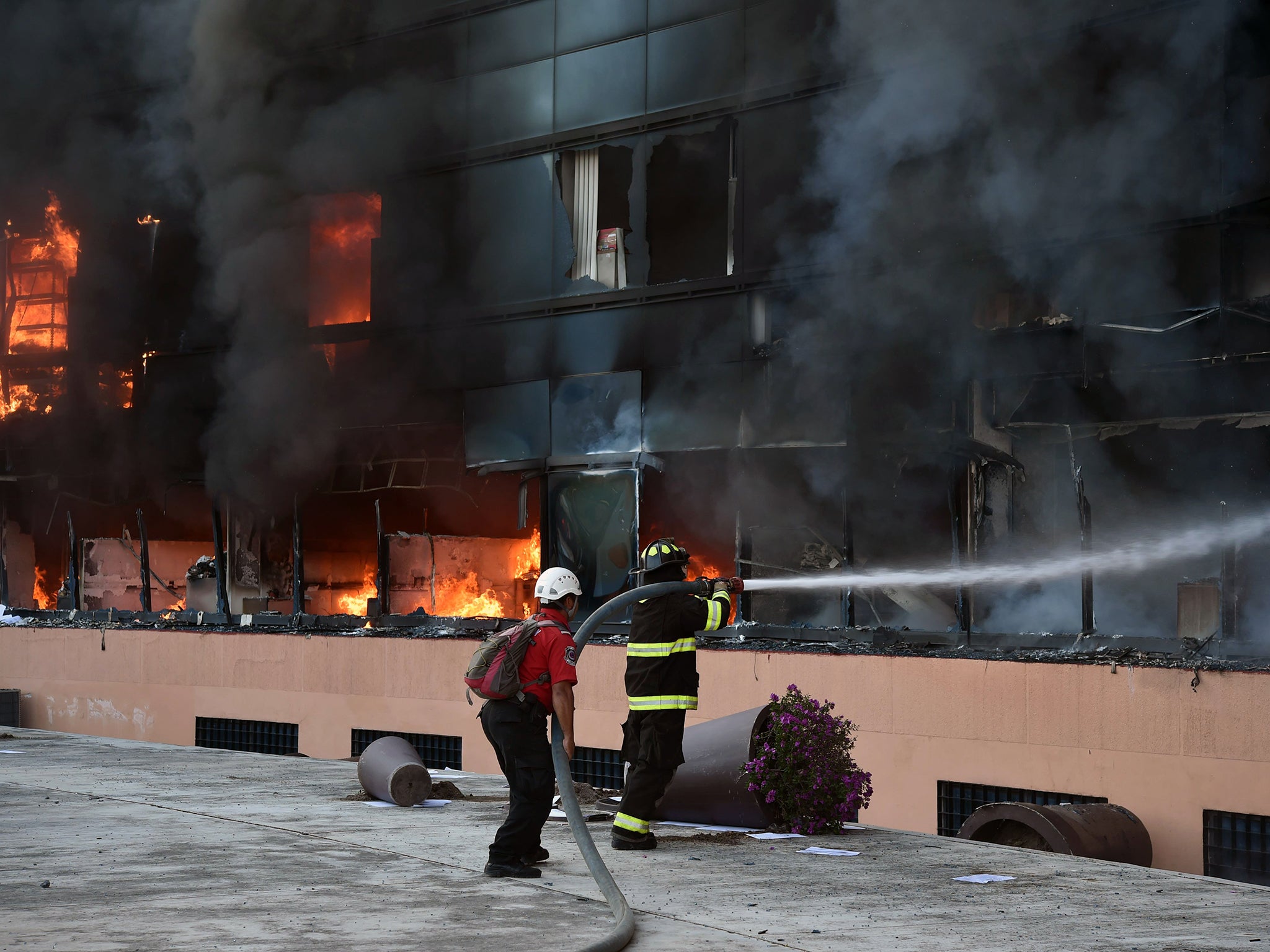 Firefighters attempt to extinguish a fire at the Municipal Palace in Chilpancingo (AFP)