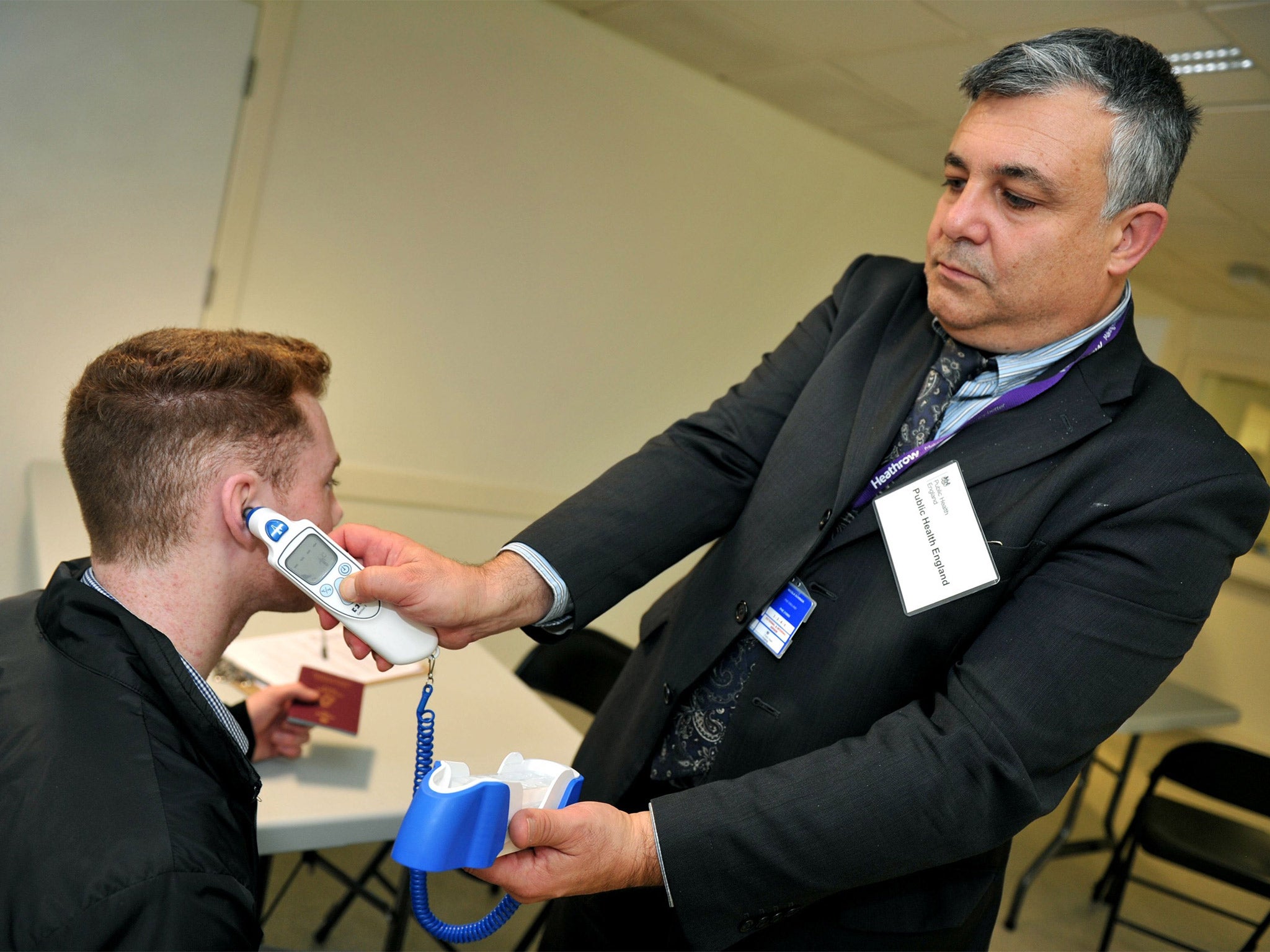 A passenger being screened at Heathrow, as enhanced measures for Ebola began at Britain's biggest airport