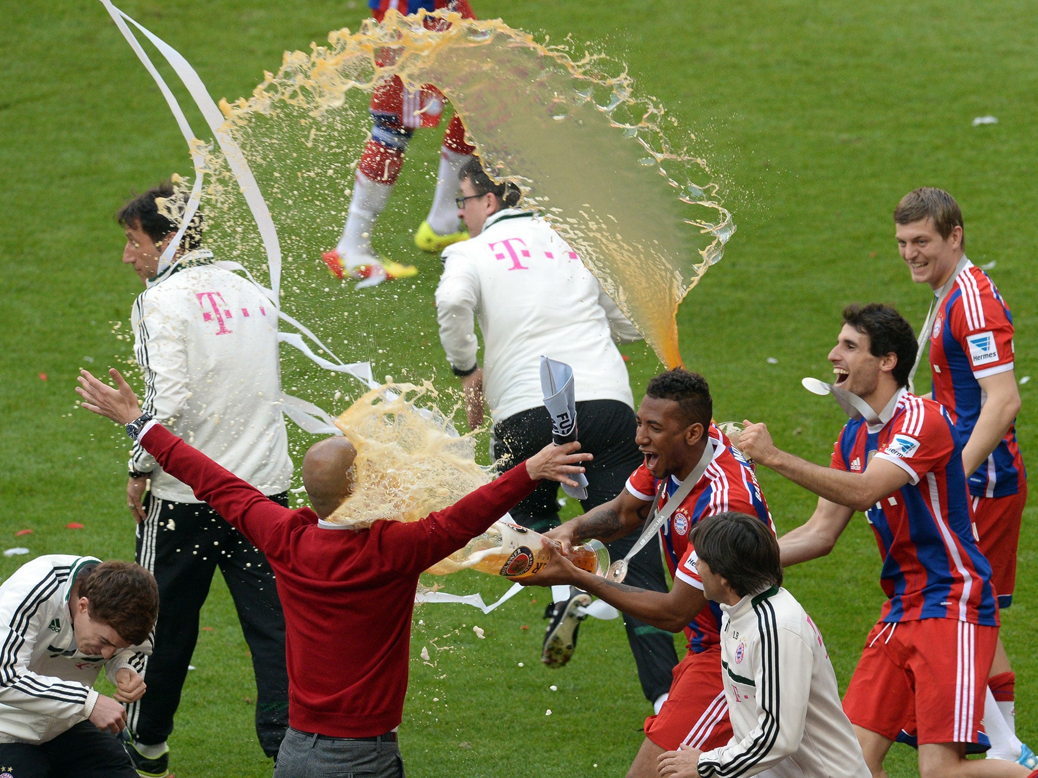 Pep Guardiola is sprayed with beer by his Bayern Munich players (Getty)