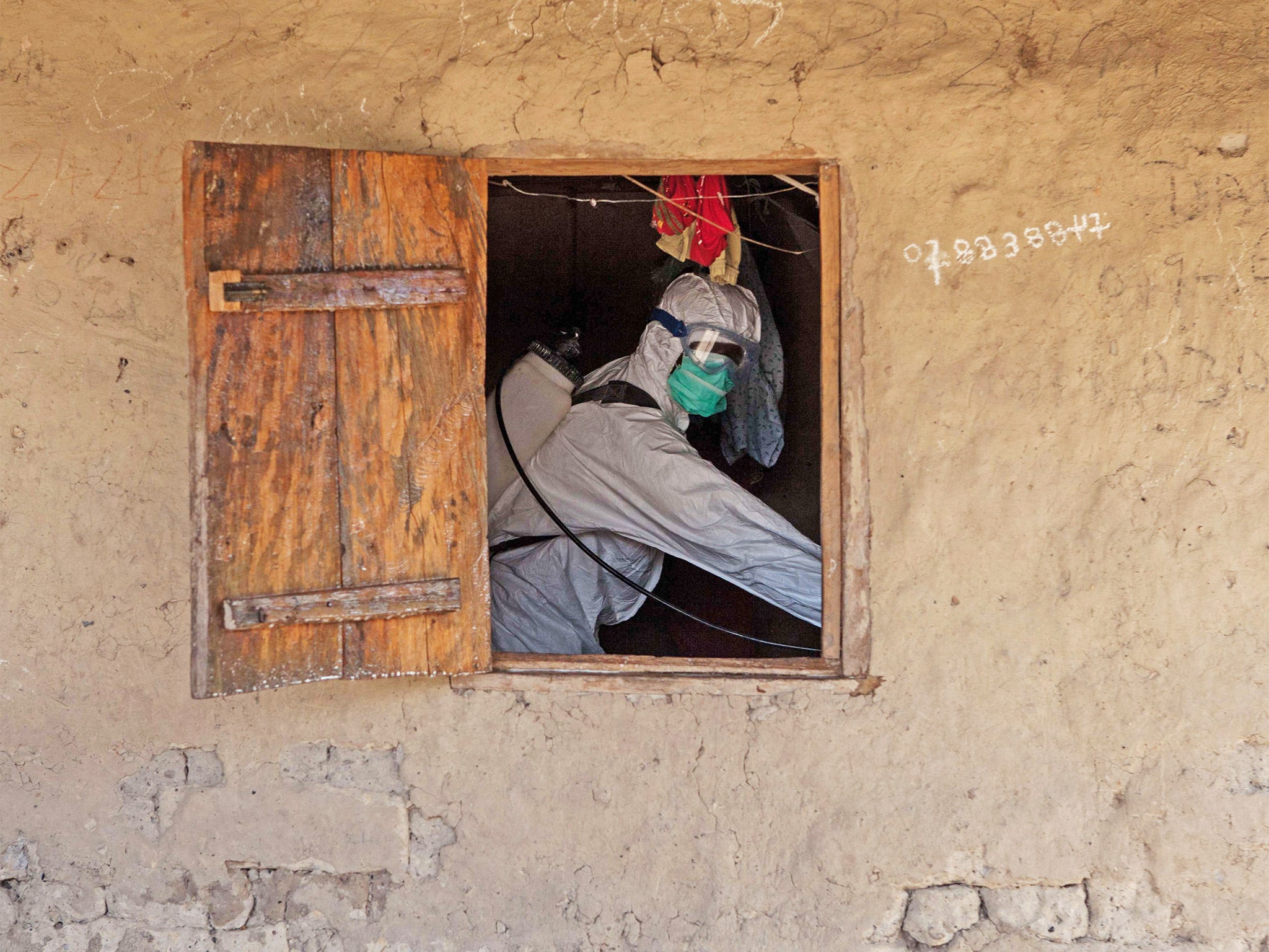 A dwelling is disinfected in Magbonkoh, Sierra Leone (Getty)