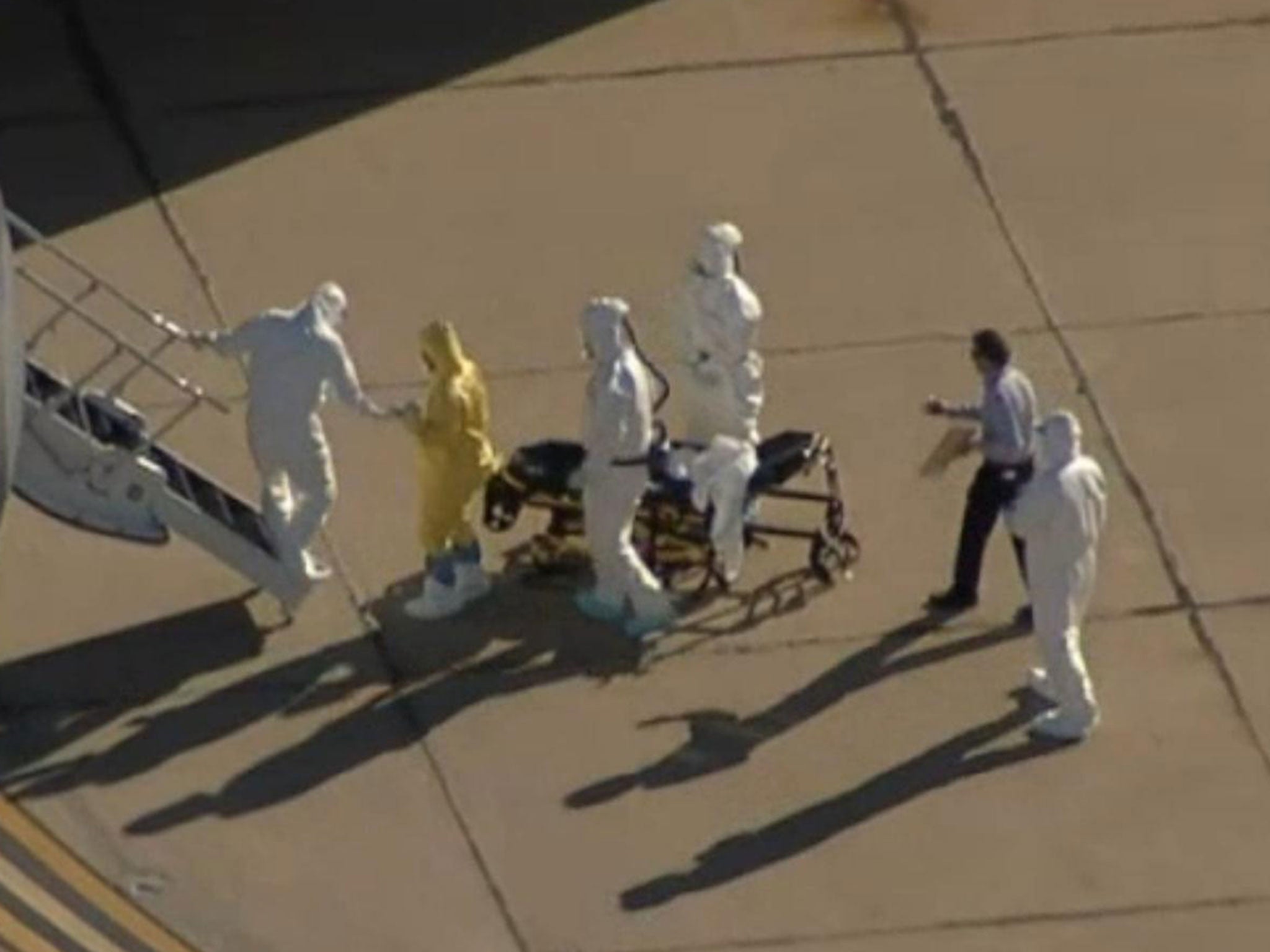 The man was seen following the stretcher carrying the patient with Ebola