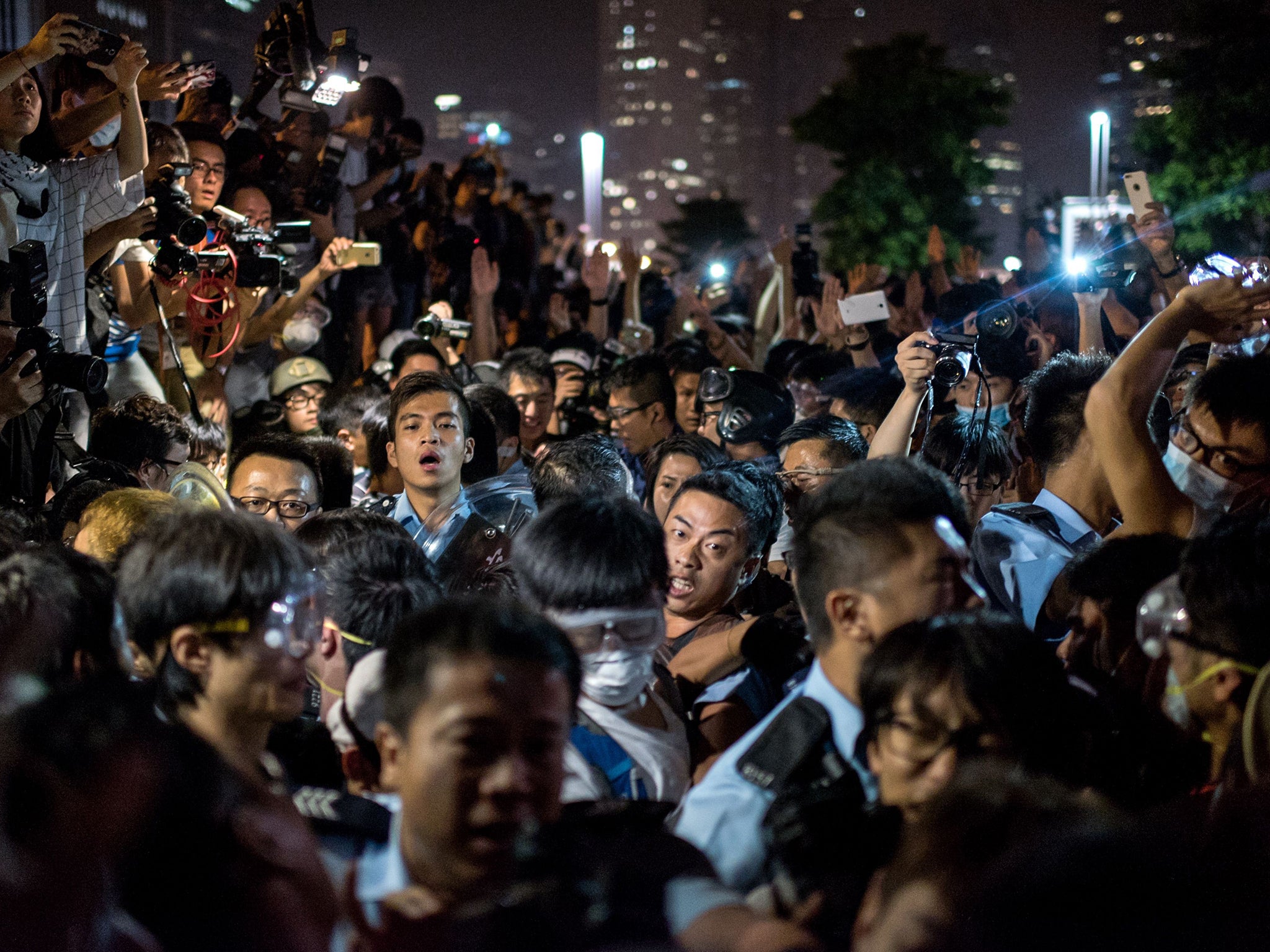 Police force their way through a crowd of pro-democracy
protesters in Hong Kong yesterday