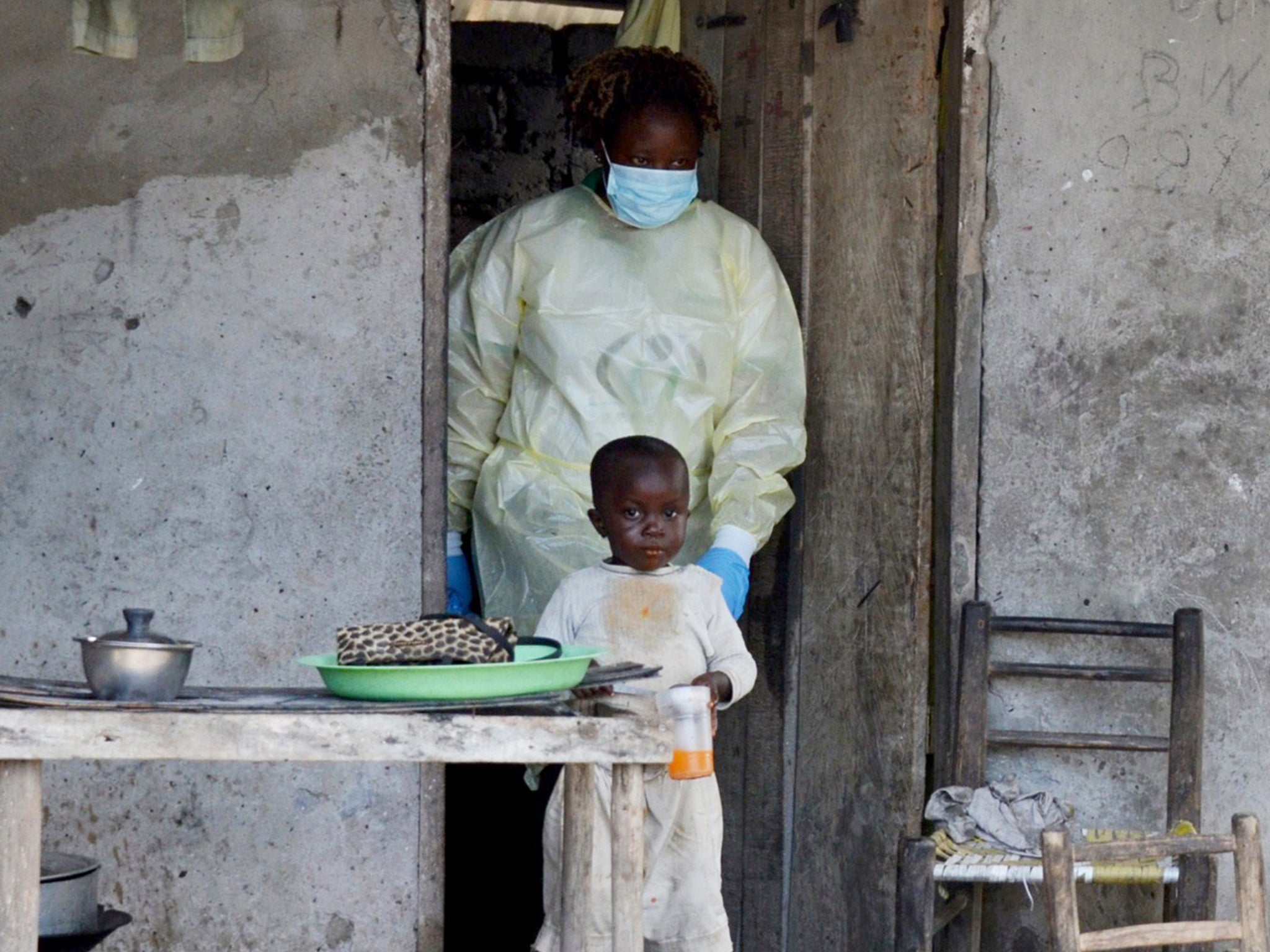 A member of the NGO U Fondation leaves a house after visiting quarantined family members suffering from the Ebola virus in Monrovia