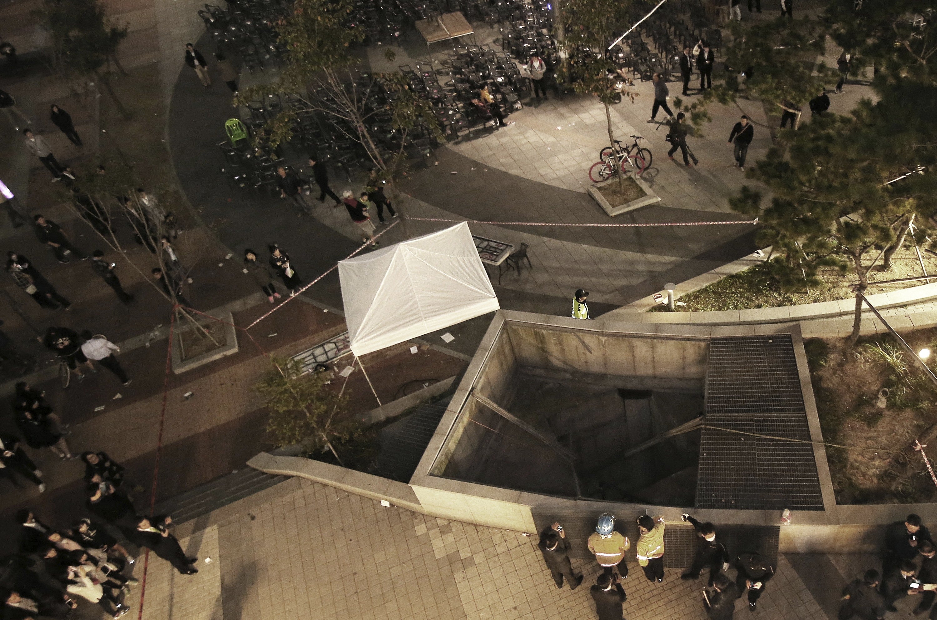 Rescue workers gather around the collapsed ventilation shaft