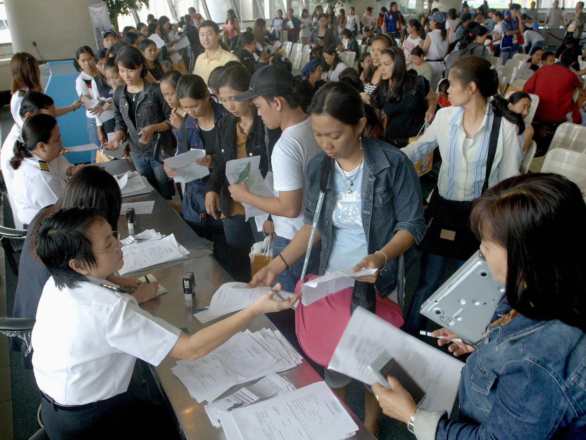 People queuing at immigration at Manila's international airport