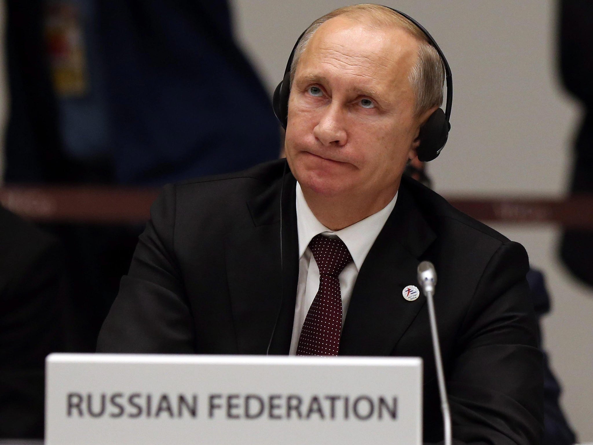 Russian President Vladimir Putin reacts during the closing press conference of the ASEM summit in Milan, Italy