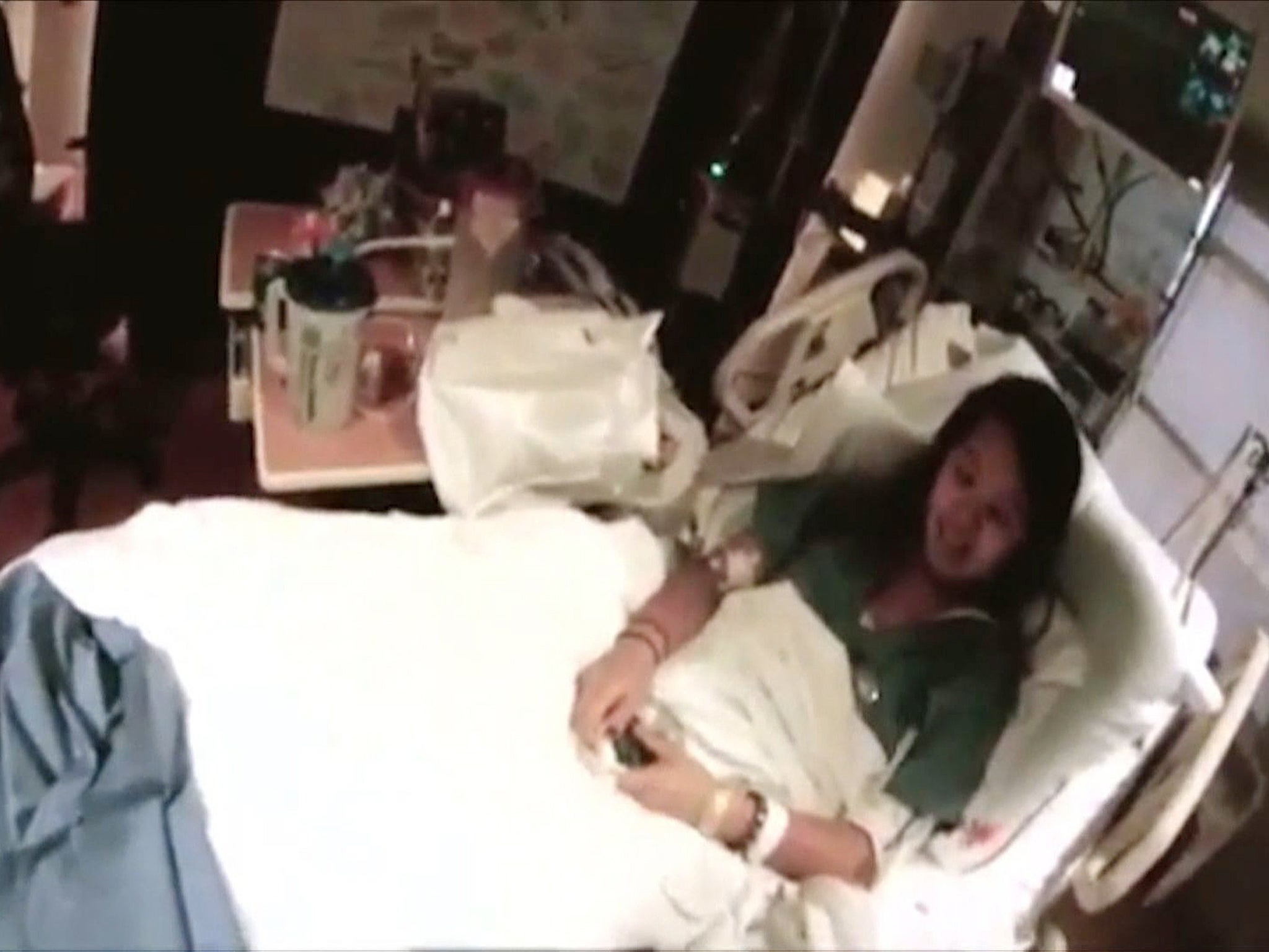 Nurse Nina Pham lies on her hospital bed at the Texas Health Presbyterian Hospital in Dallas, Texas