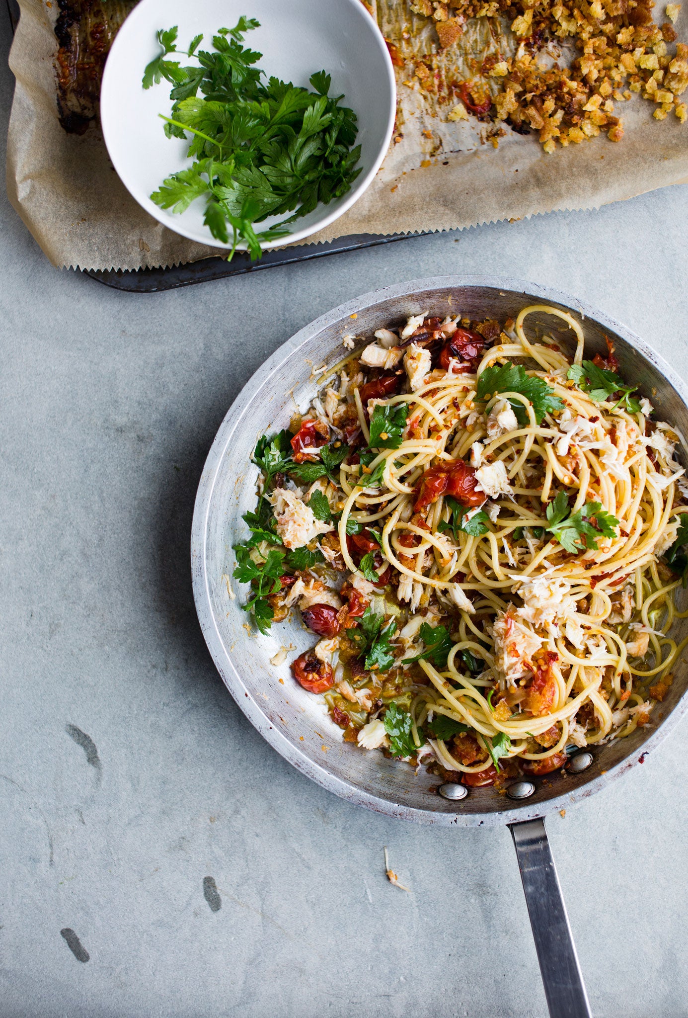 Spaghetti with crab and cherry tomatoes cooked in garlic and chilli