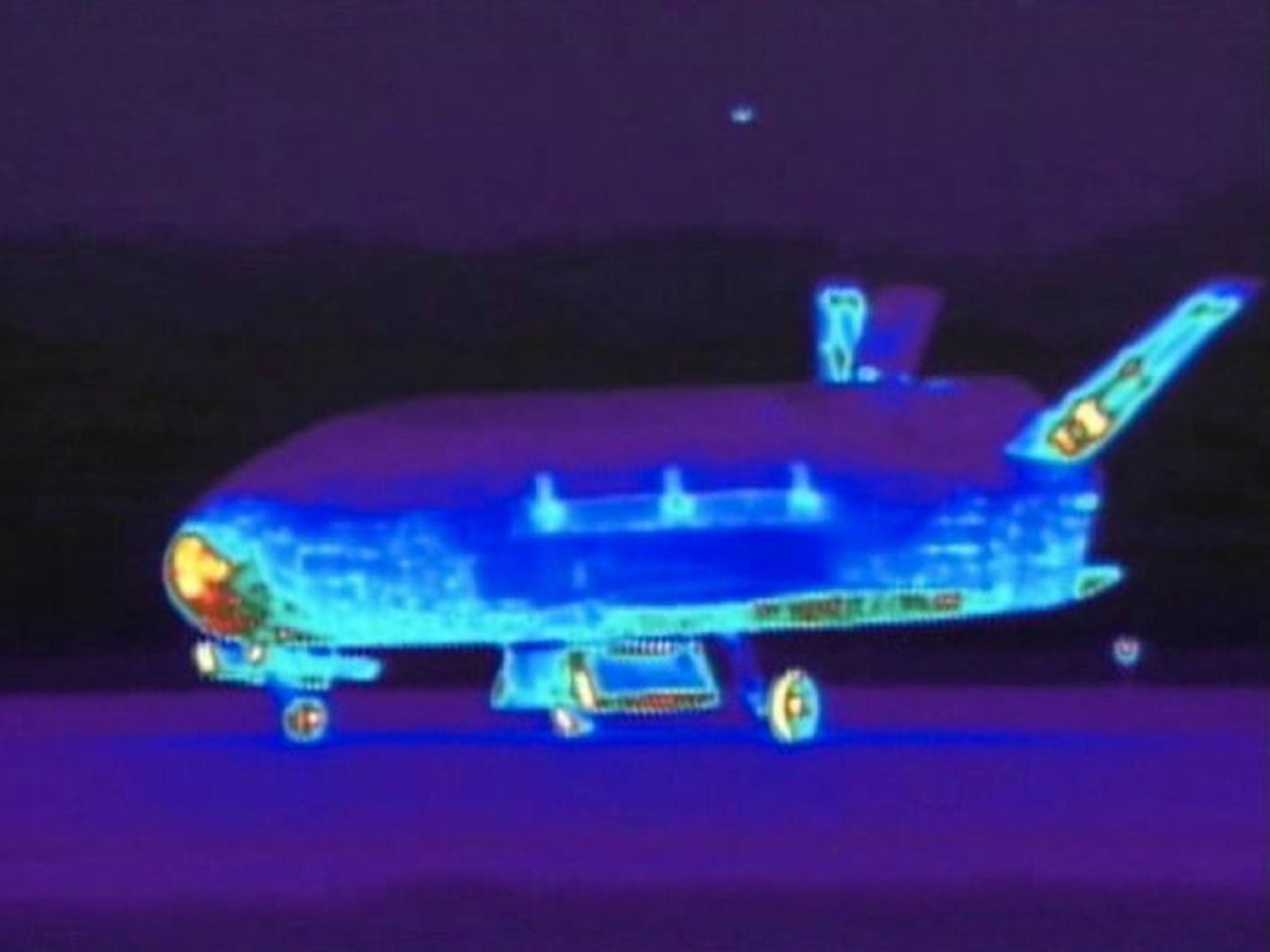 This June 16, 2012 file image from video made available by the Vandenberg Air Force Base shows an infrared view of the X-37B unmanned spacecraft landing at Vandenberg Air Force Base.