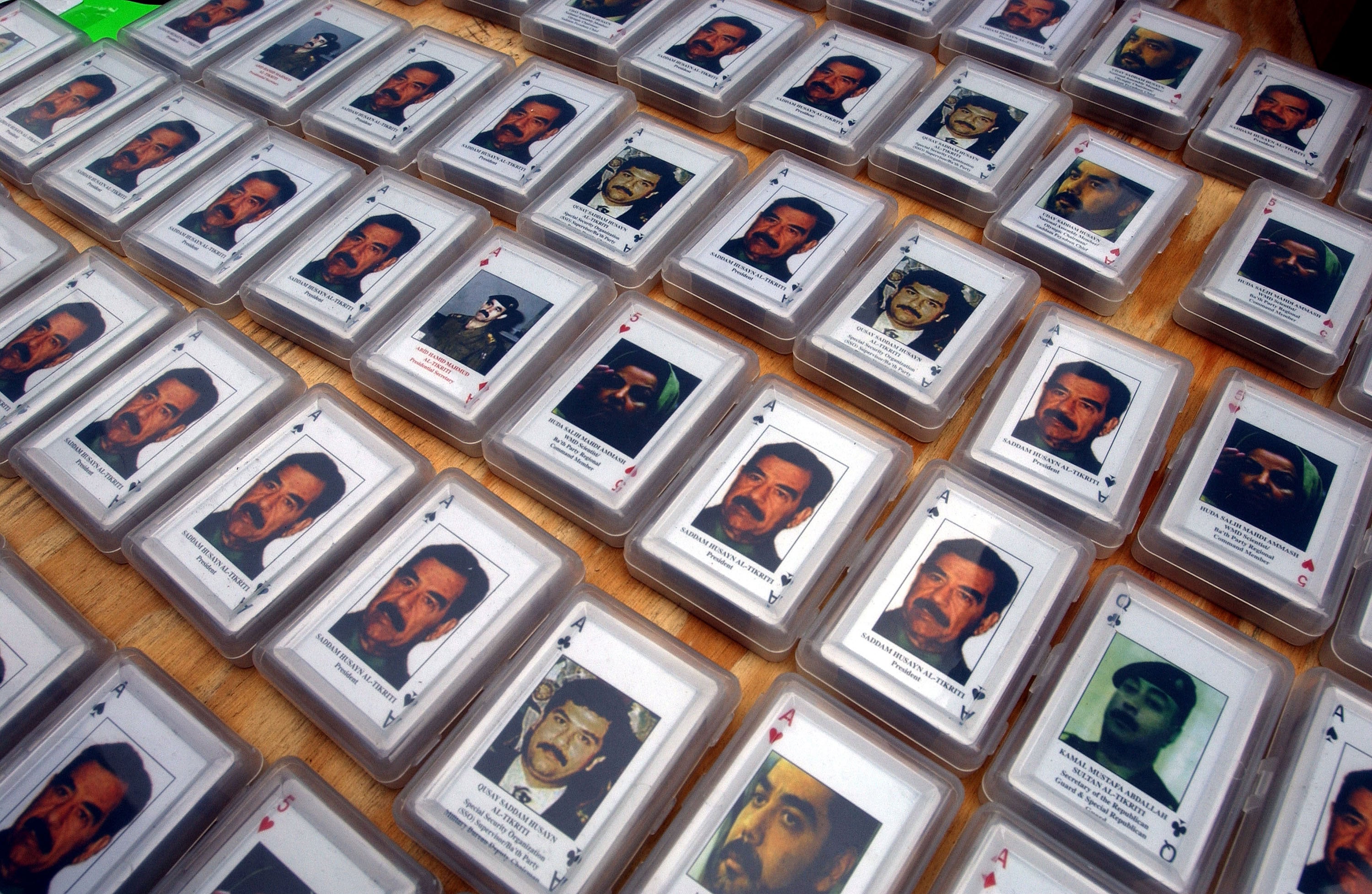 Playing cards featuring the U.S. Central Commands 54 most wanted members of Saddam Hussein's regime sit for sale on a table May 15, 2003 in New York City.