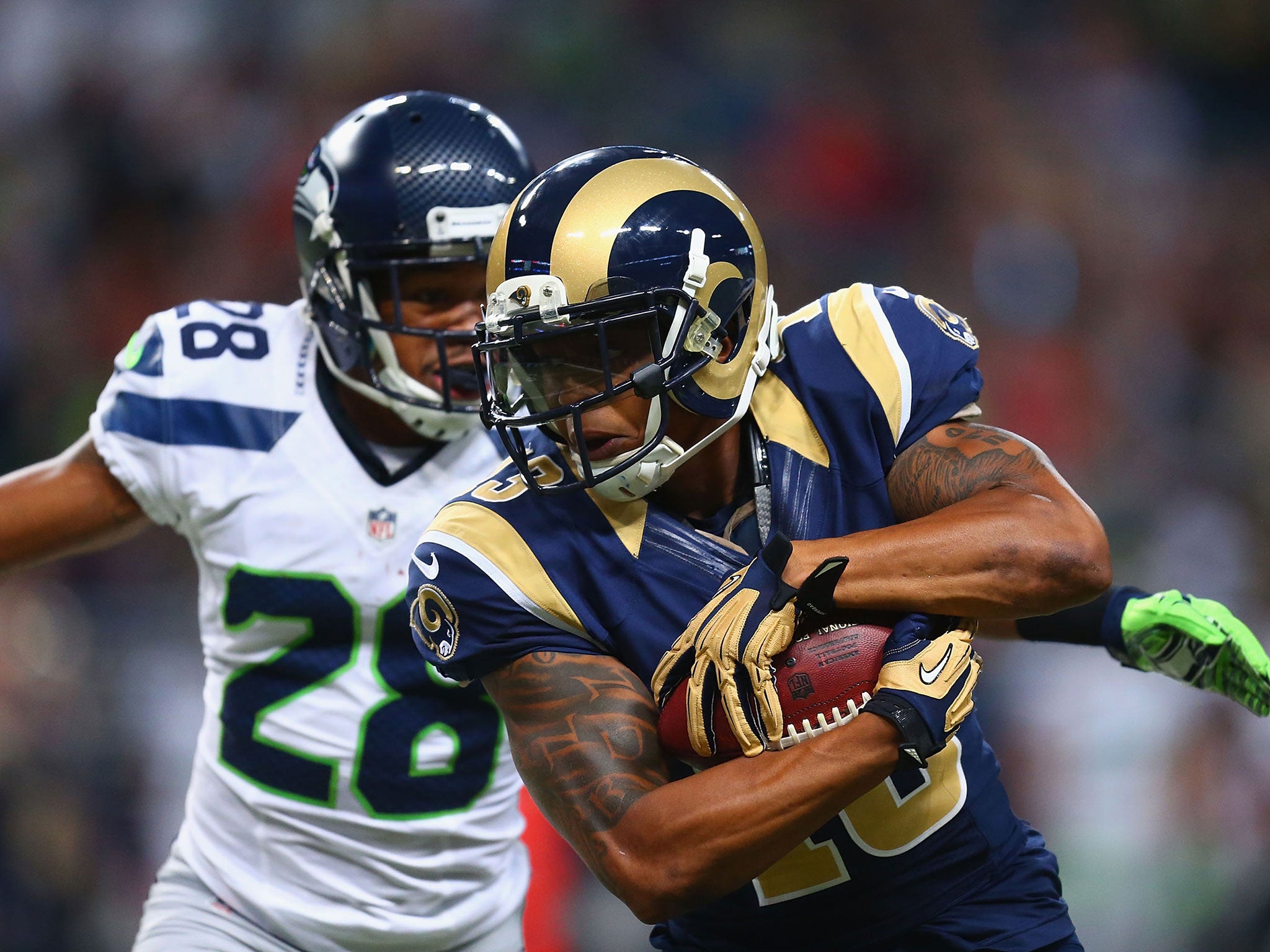 Chris Givens of the St. Louis Rams makes a catch against Marcus Burley of the Seattle Seahawks