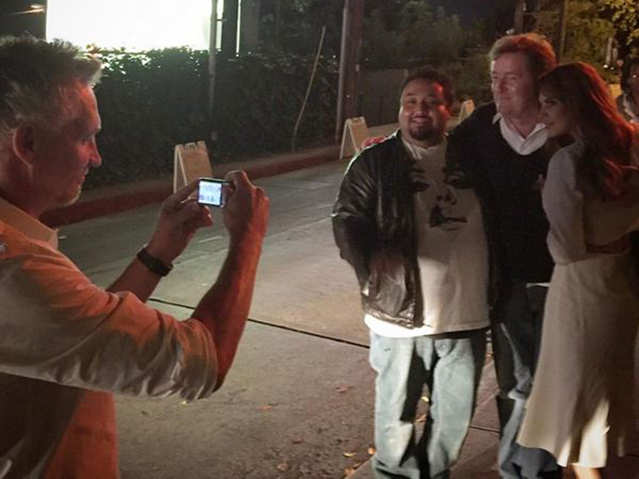 Gary Lineker takes a picture of an American alongside Piers Morgan and Danielle Bux