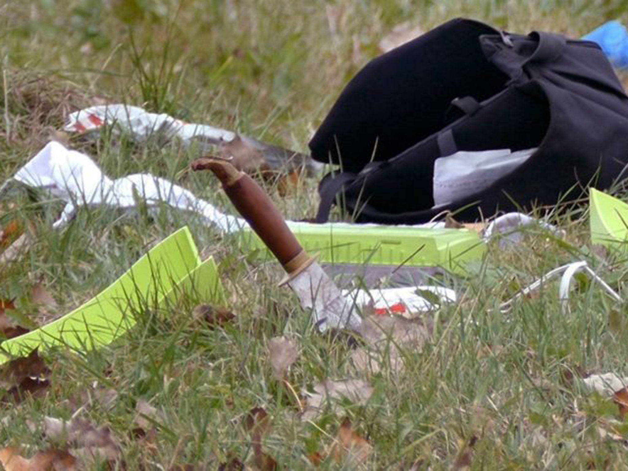 A knife stuck in the ground near Martin Rouleau's overturned car