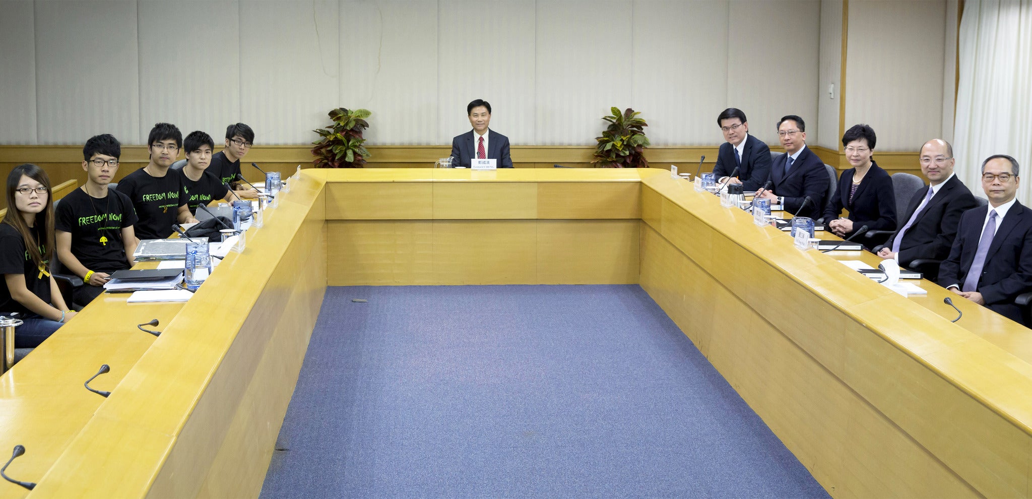 Students protesters, left, face government officials in negotiations