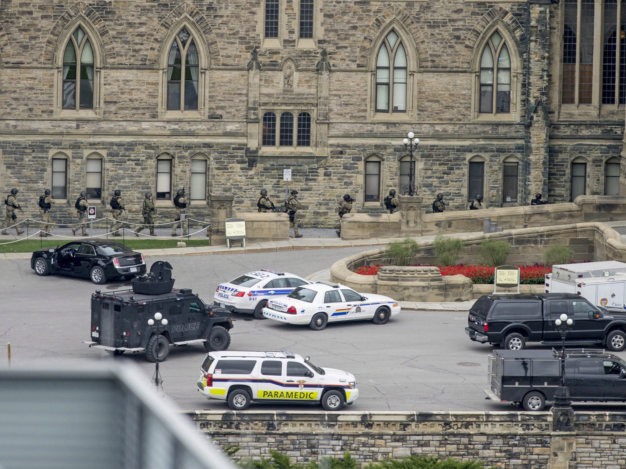 Armed police teams enter Centre Block at Parliament Hill in Ottawa