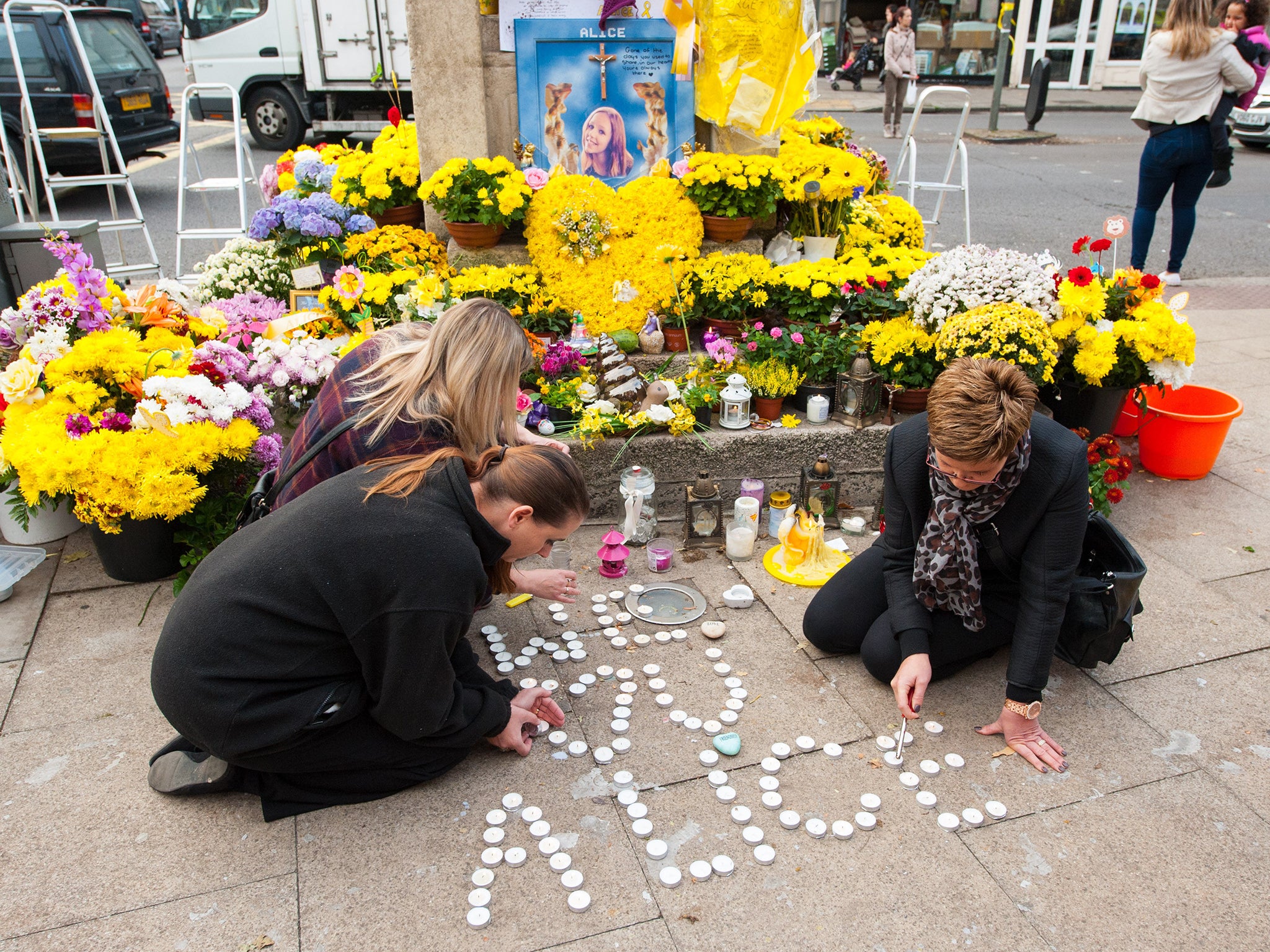 Mourners light candles in memory of murdered teenager Alice Gross at Hanwell Clock Tower