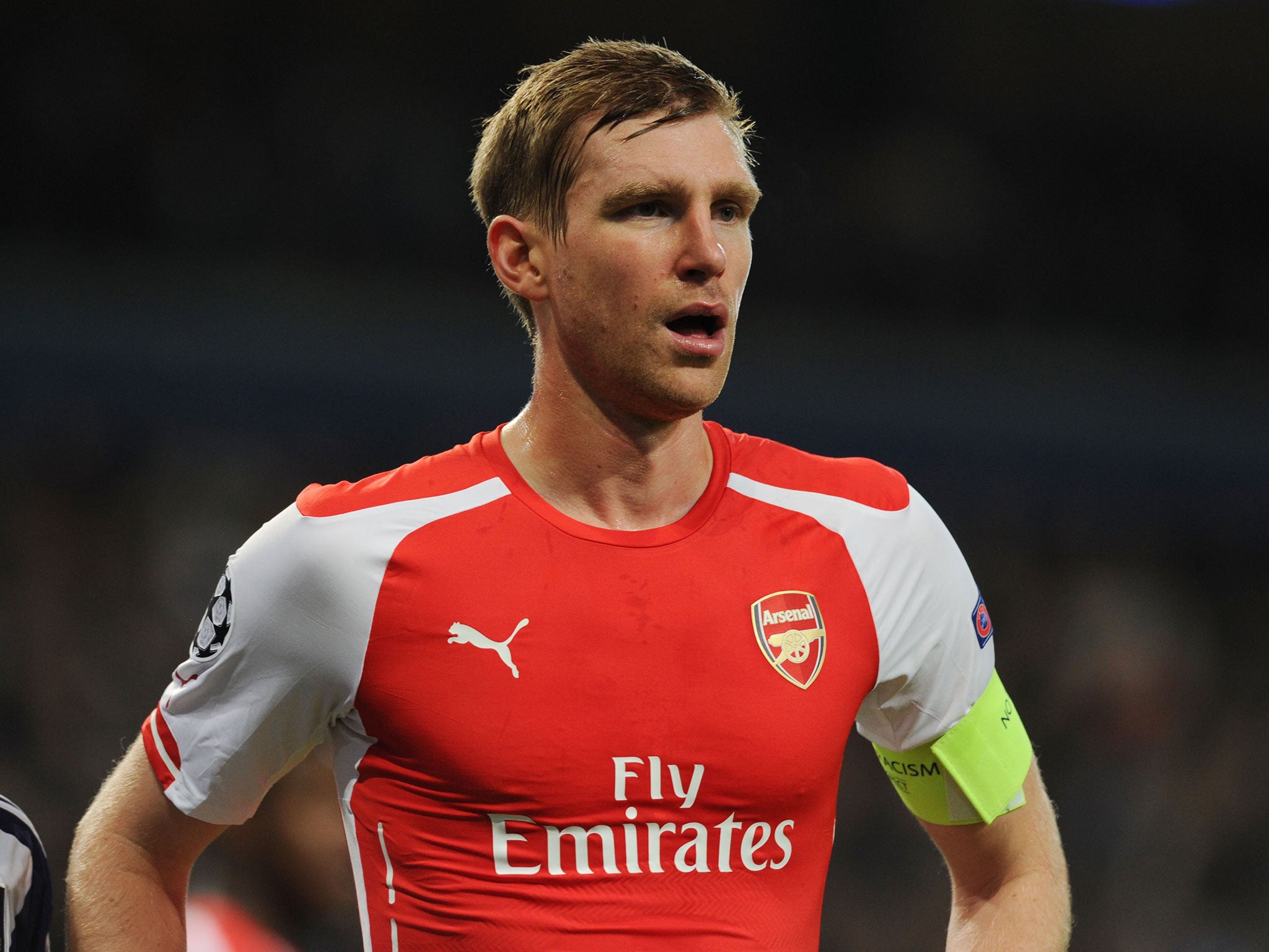 Per Mertesacker looks on in Brussels last night