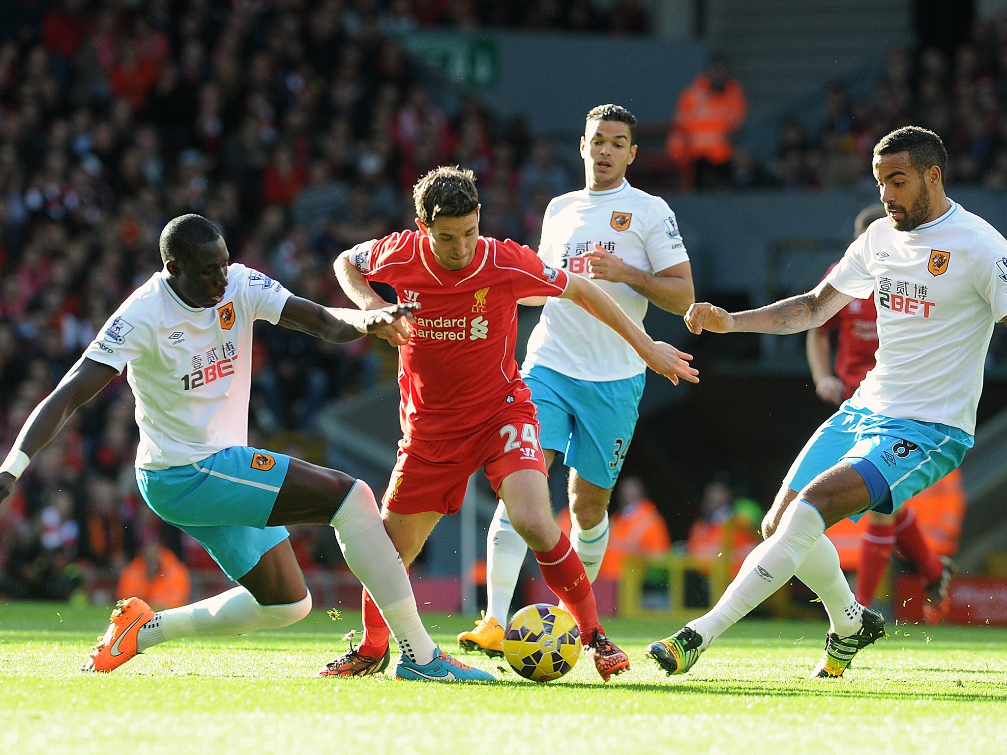 Joe Allen of Liverpool runs through the Hull players