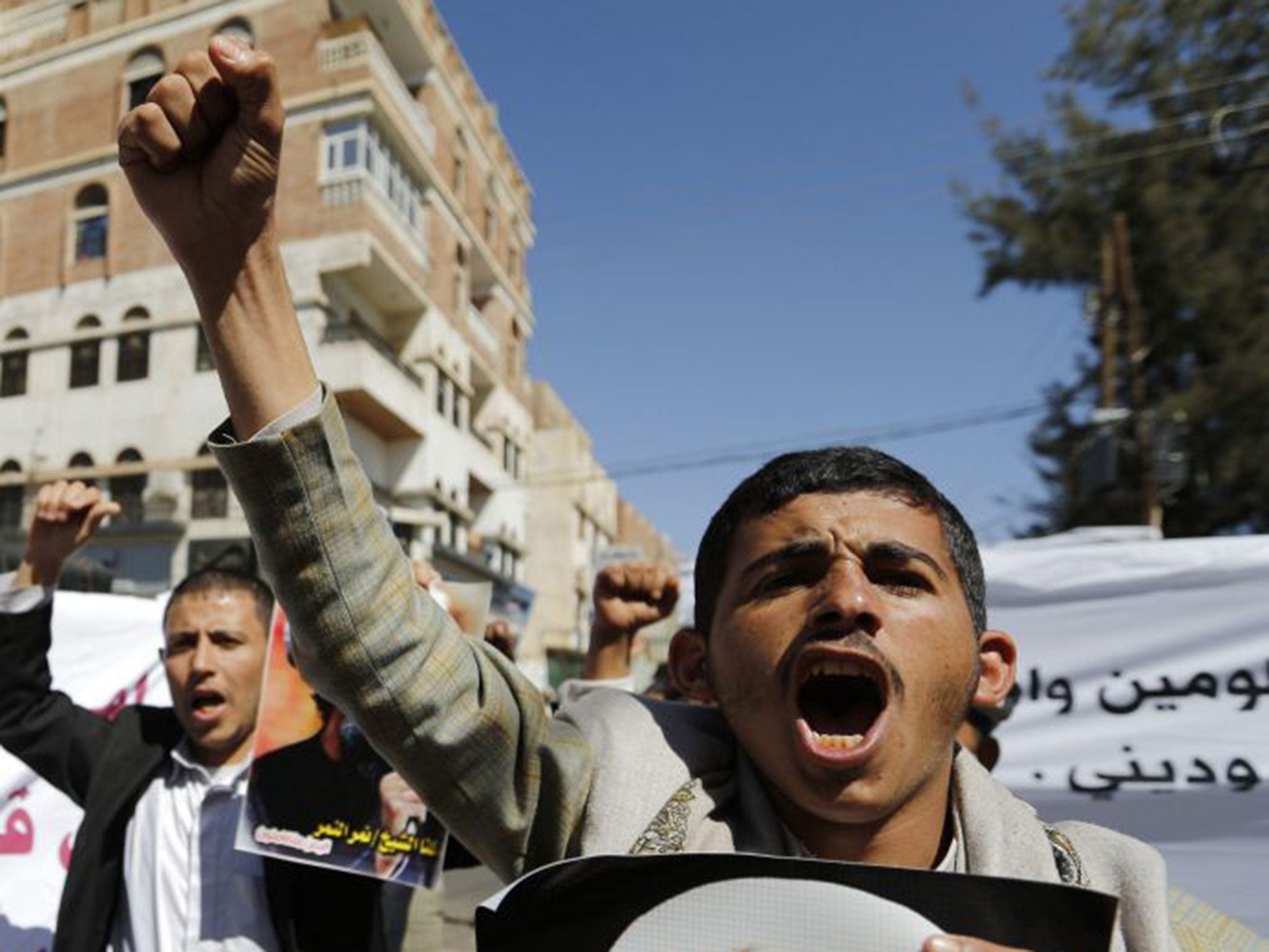 Shia protesters hold pictures of Sheikh Nimr al-Nimr Khaled Abdullah