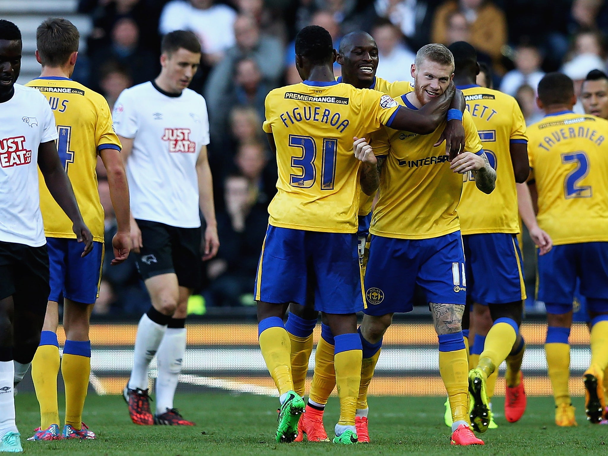 James McClean of Wigan Athletic is congratulated on his goal