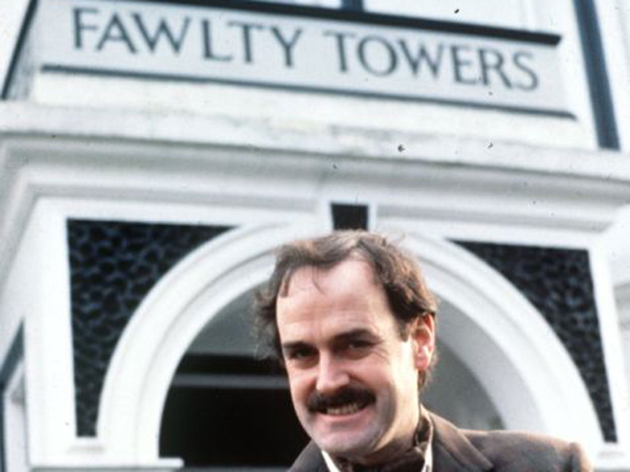 John Cleese as Basil Fawlty, whose hotel is a byword for poor service