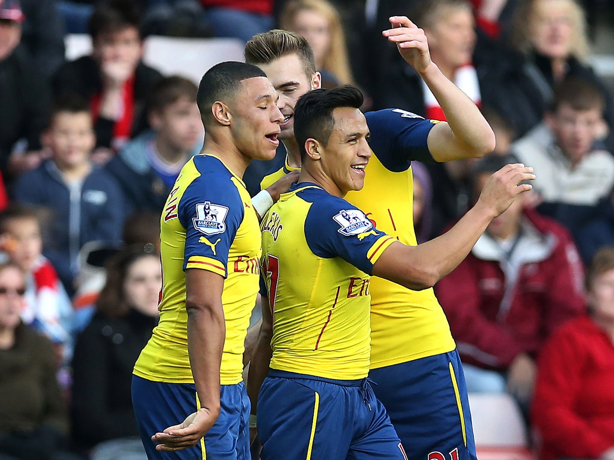 Alex Oxlade-Chamberlain (left) celebrates with Alexis Sanchez on Saturday