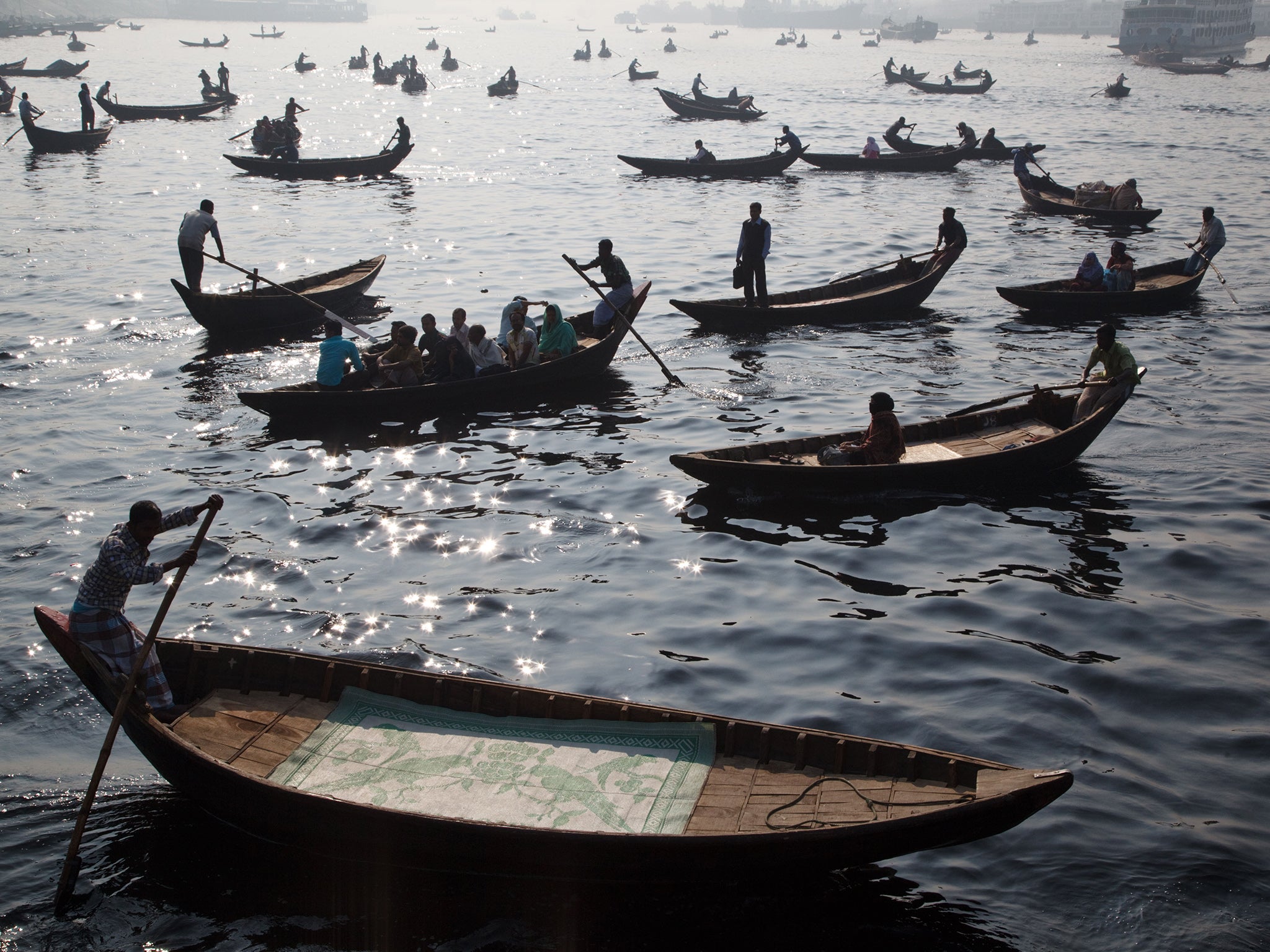 Taxi boats with commuters crossing Buriganga river, Dhaka, Bangladesh.