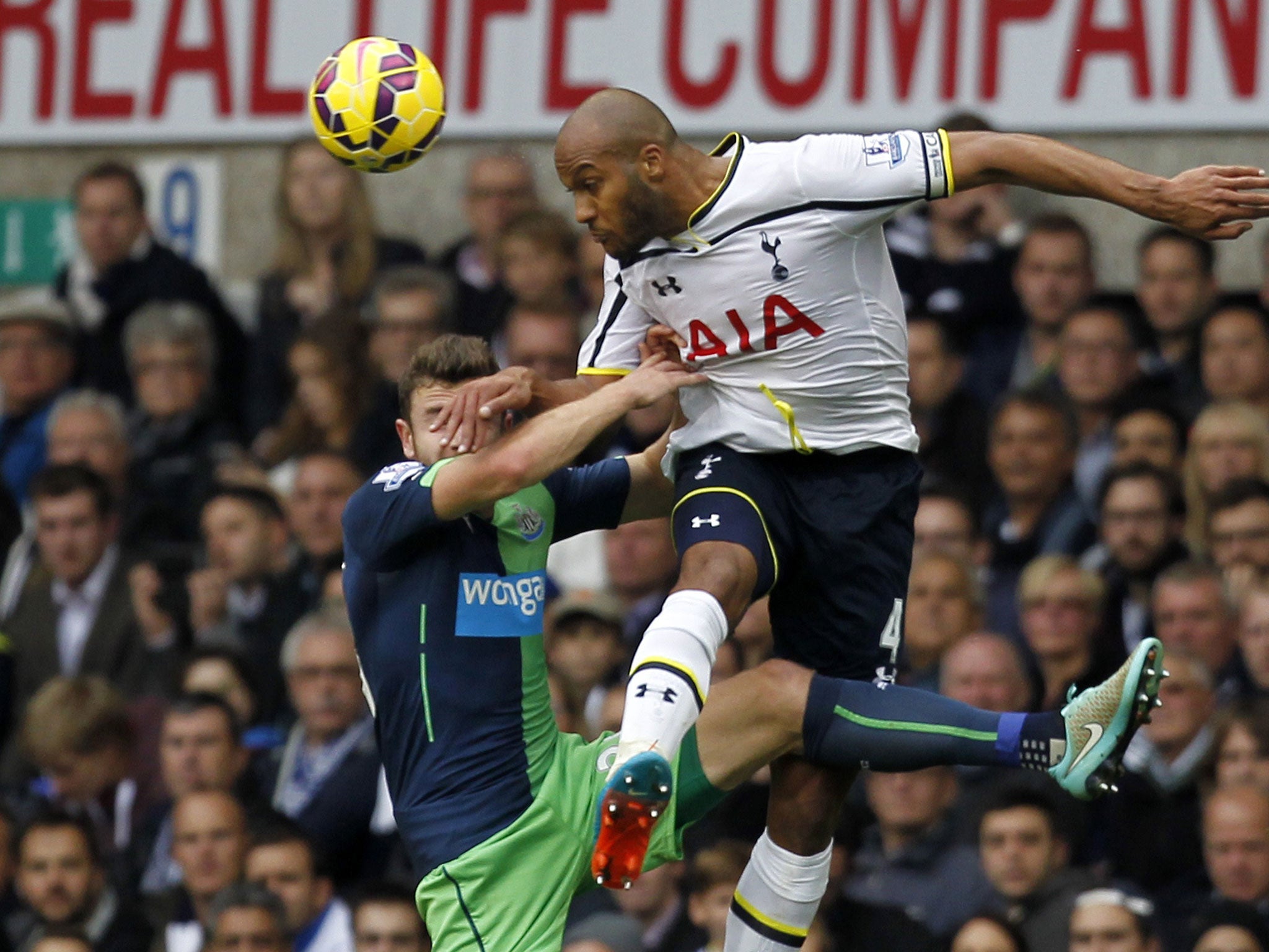 Younes Kaboul challenges Paul Dummett in the air