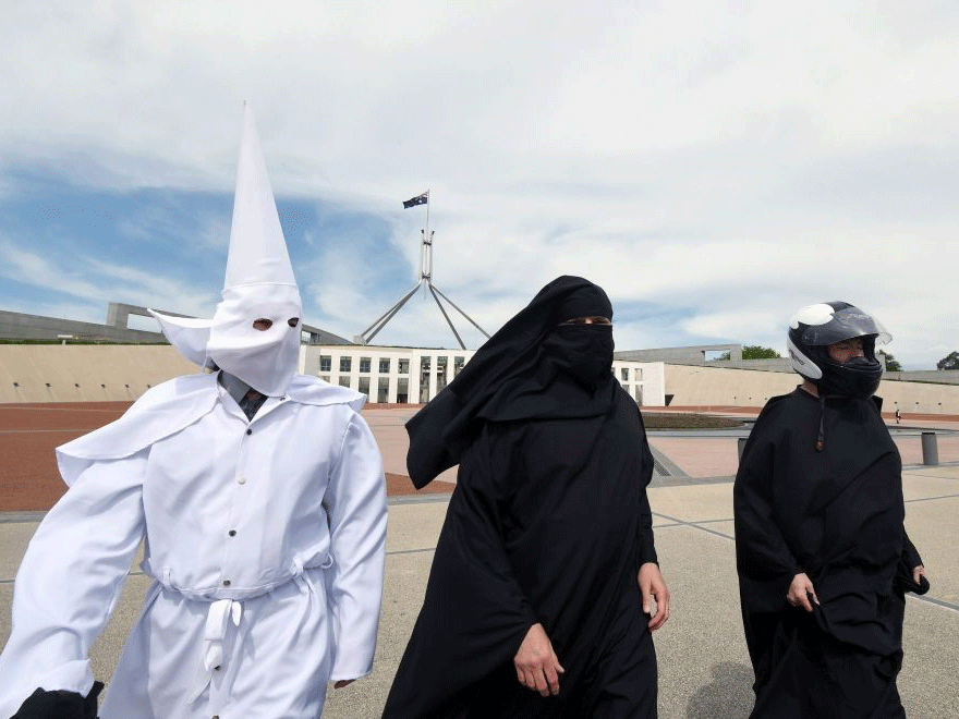 Three protesters attempted to enter the Australian parliament wearing a Ku Klux Klan hood, a motorcycle helmet and a niqab in an anti-burqa demonstration.