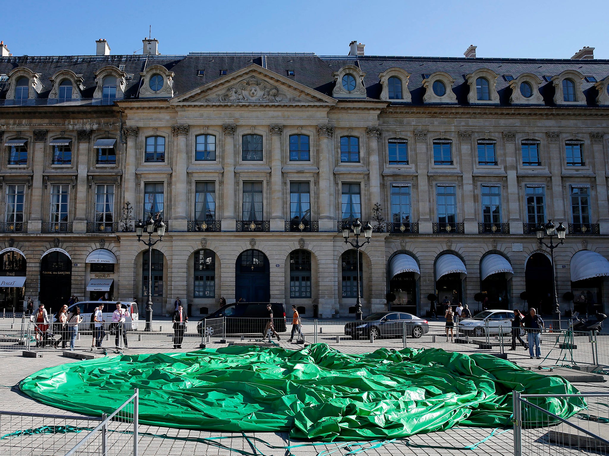 A general view of the controversial inflatable sculpture entitled 'Tree' by US artist Paul McCarthy, that was vandalized over night, at the Place Vendome in Paris, France, 18 October 2014