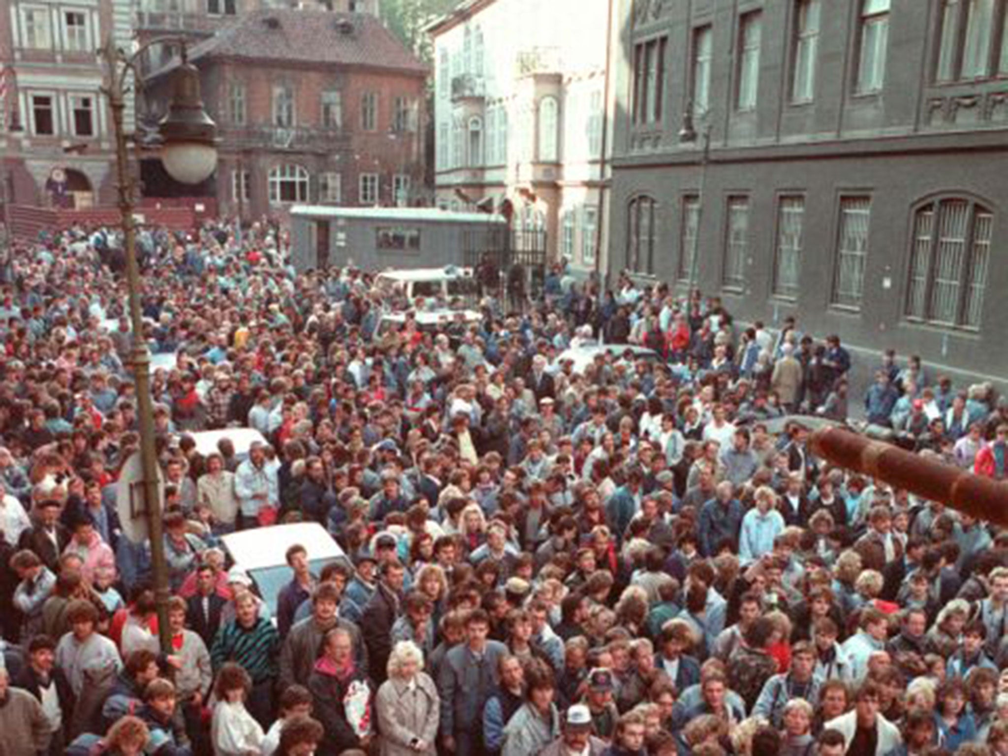 East German refugees outside the West German embassy in Prague in October 1989 waiting to take a train for the West