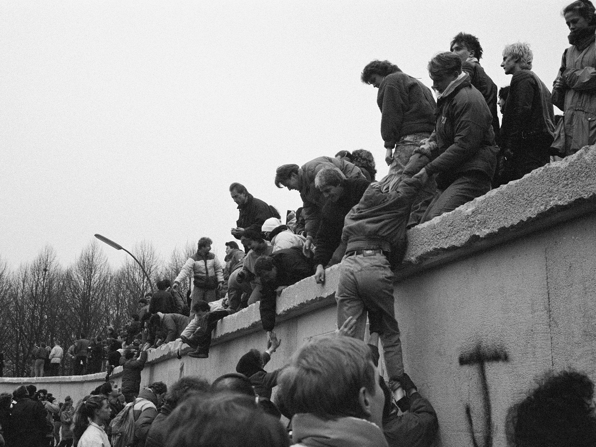 East Berliners climb onto the Berlin Wall to celebrate the effective end of the city's partition, 31st December 1989 (Getty Images)