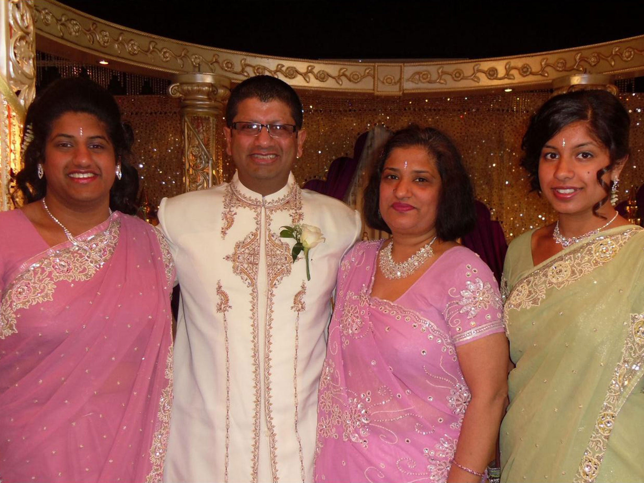 Jatindra Lad, 49, centre, with his wife Daksha, 44, centre right, and their two children, Trisha, 19, left, and Nisha, 16, right