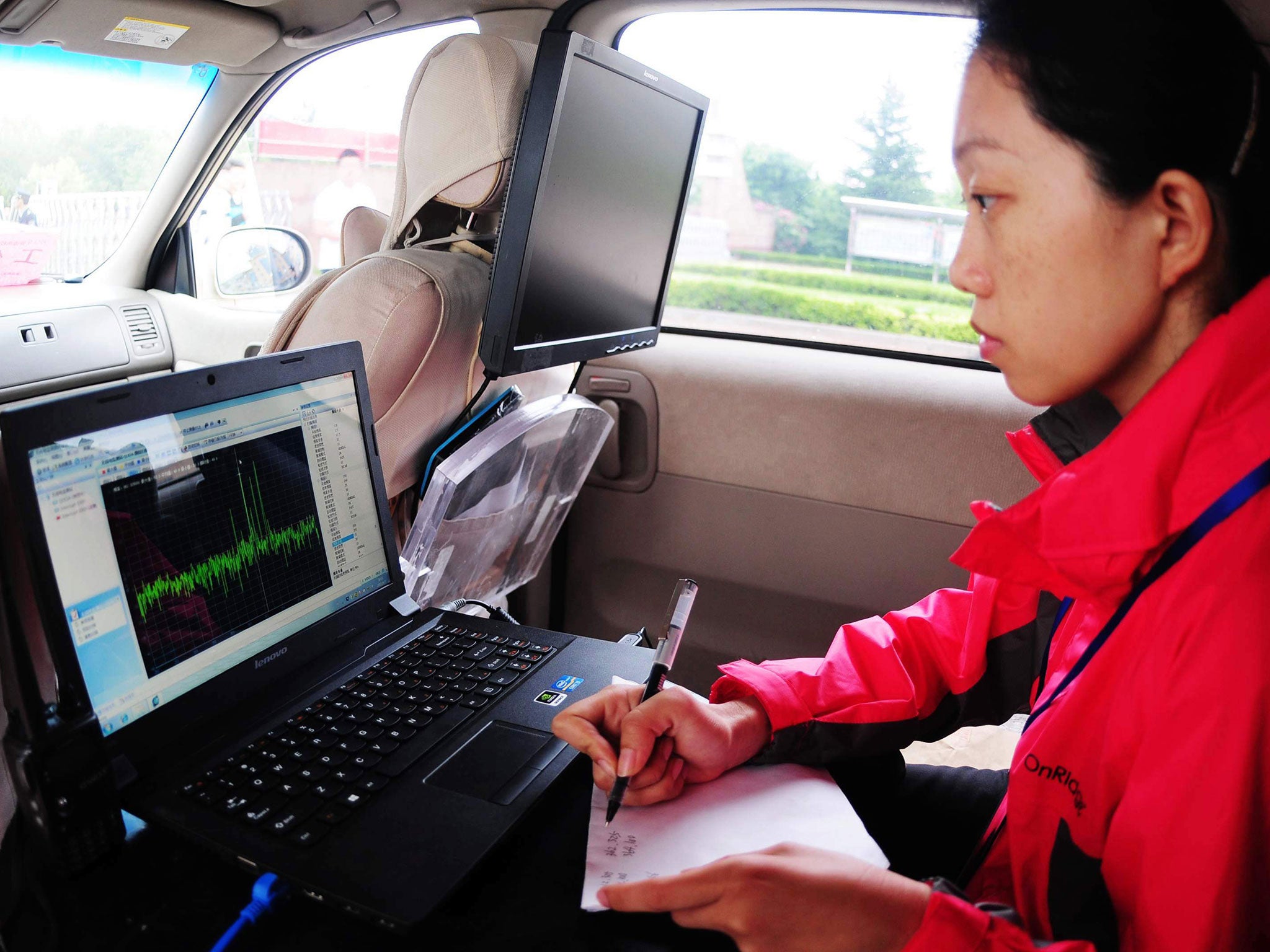 A staff member monitors radio signals to prevent students cheating during the 2013 university entrance exam in Qingdao, east China's Shandong province on June 7, 2013.