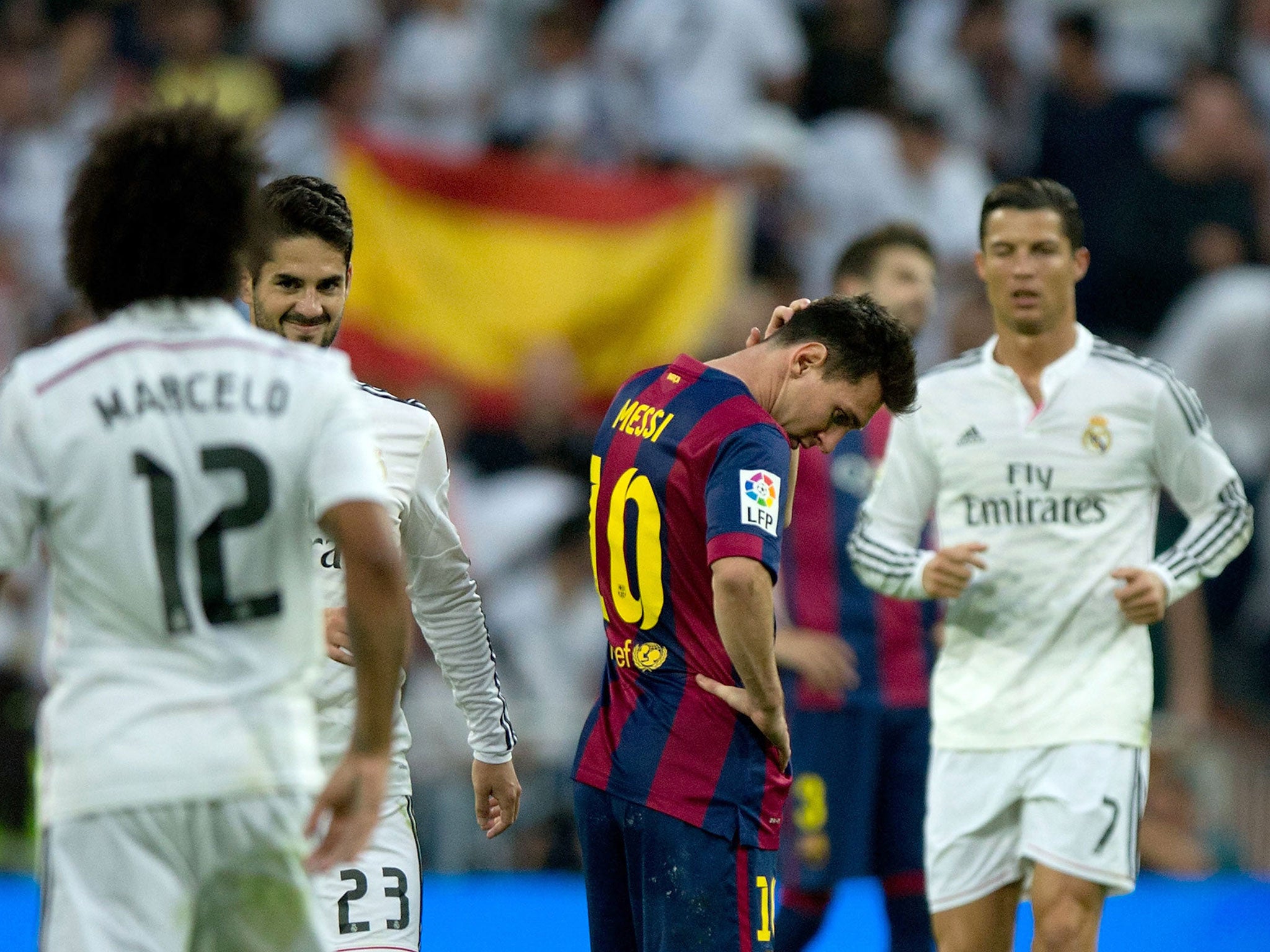 Real Madrid players Marcelo, Isco and Cristiano Ronaldo celebrate as Lionel Messi looks dejected