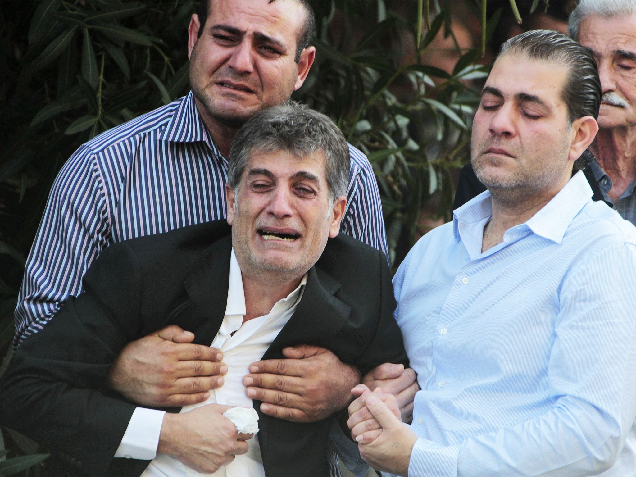 Relatives of Lieutenant Nadim Semaan, who was killed during fighting between Lebanese army soldiers and Islamist militants in Tripoli, mourn during a ceremony in Beirut