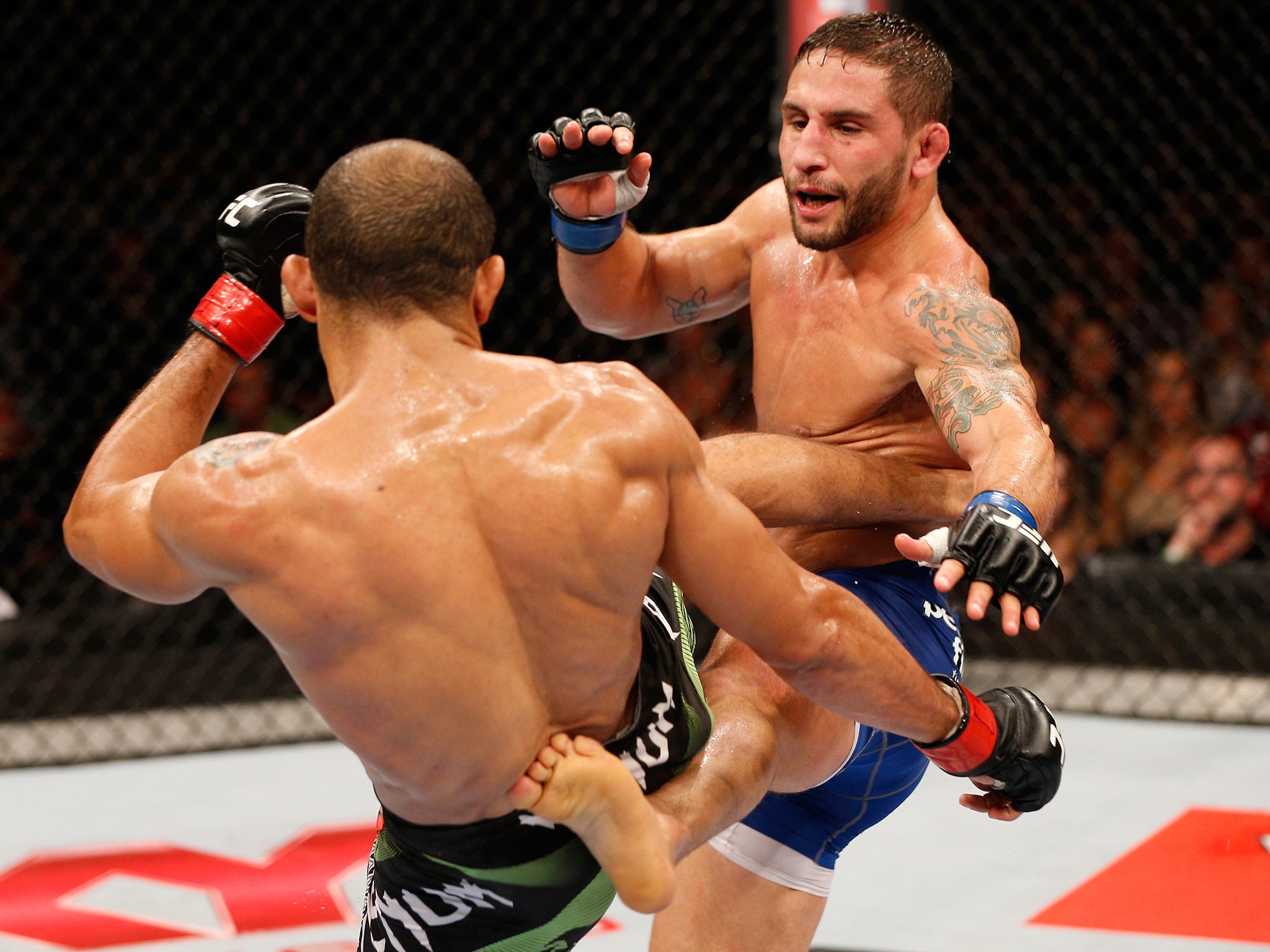 Chad Mendes and Jose Aldo trade kicks during UFC 179